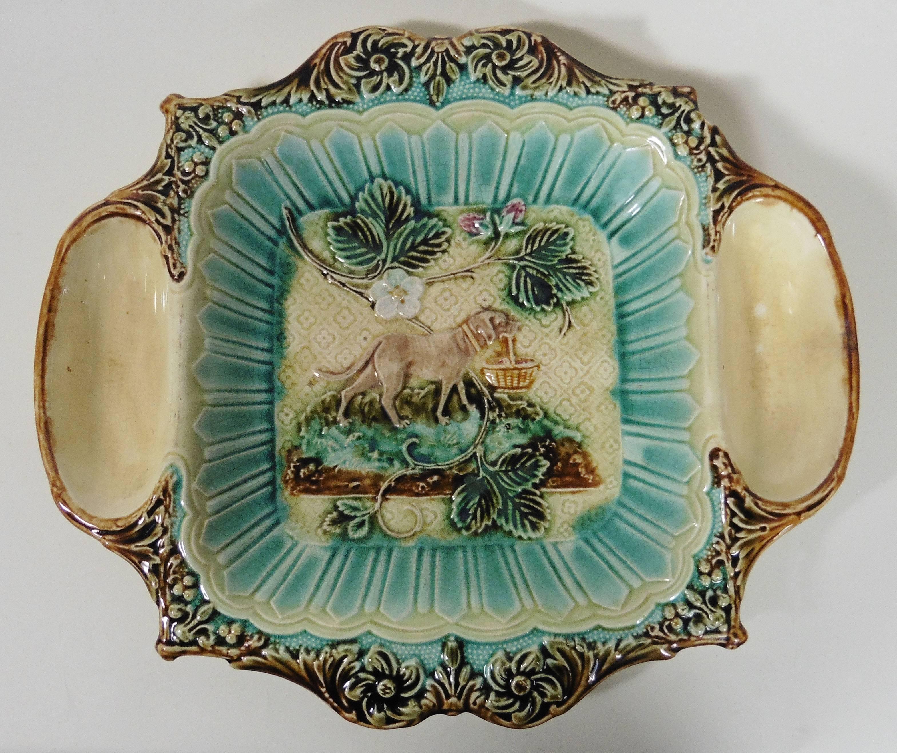 Unusual French Majolica strawberry server with cream and sugar spaces, circa 1890, attributed to Onnaing.
Sophistiqued leaves border, the centre is decorated with strawberries and a dog holding a basket.

 
