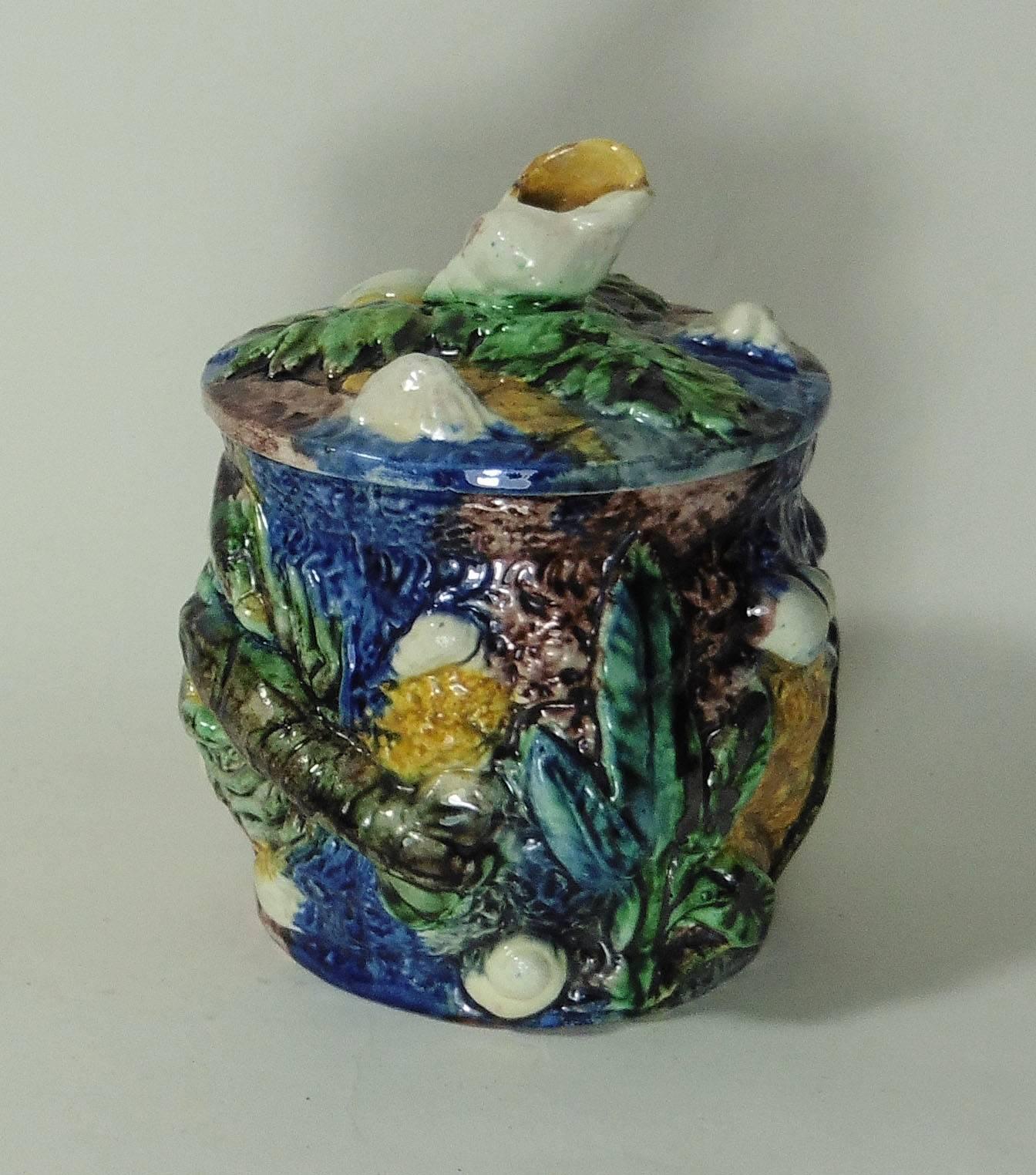 Palissy tobacco jar signed Thomas Sergent, circa 1880.
The handle is a shell, the tobacco jar is decorated with a crawfish, a lizard, shells and leaves on a mottled blue brown yellow background.
Thomas Victor Sergent was an active member of the