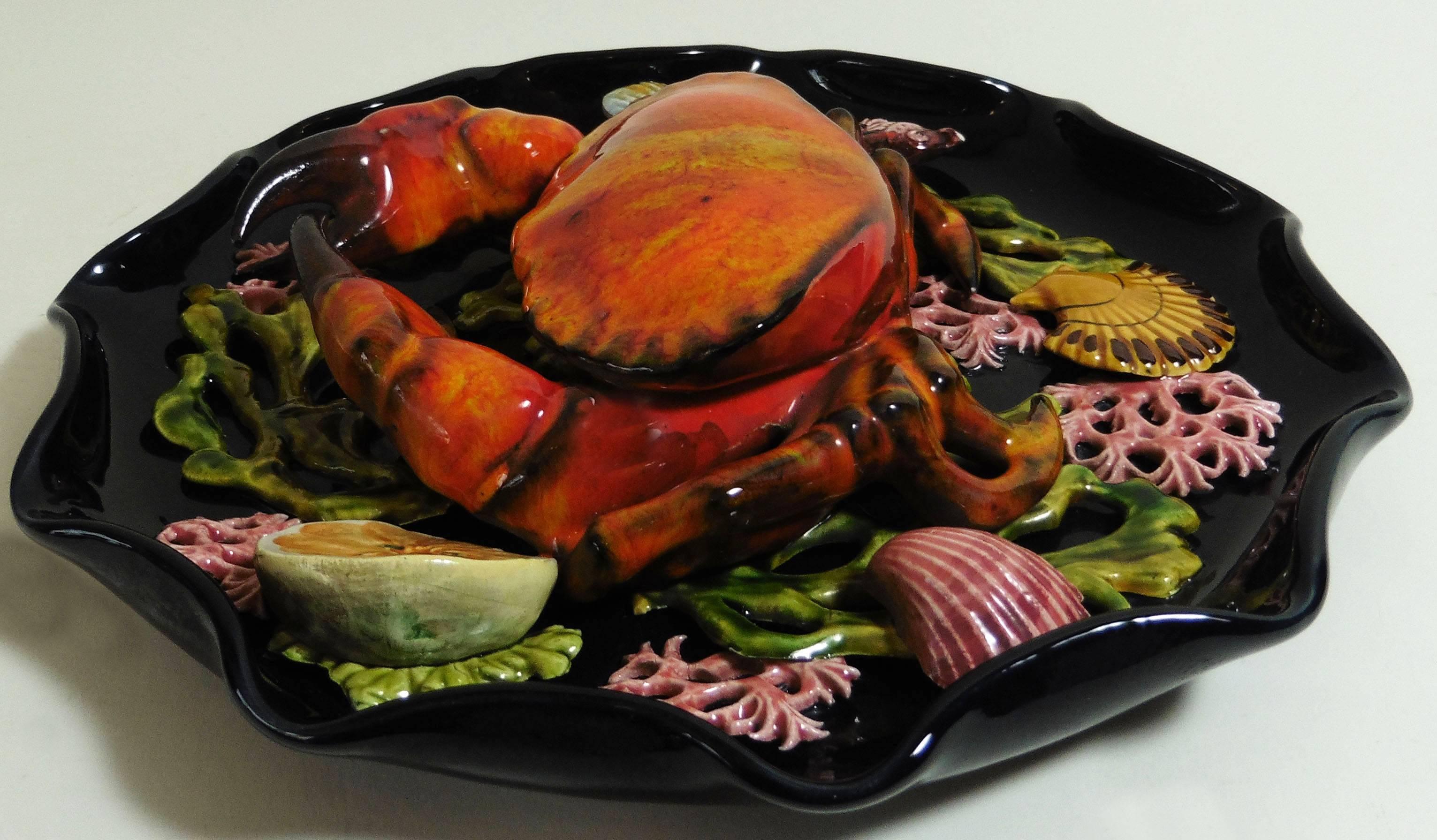 Large Majolica wall platter attributed to Vallauris, circa 1950.
A large crab in high relief on the center surrounded by seaweeds, one fish, shells and a slice of lemon.