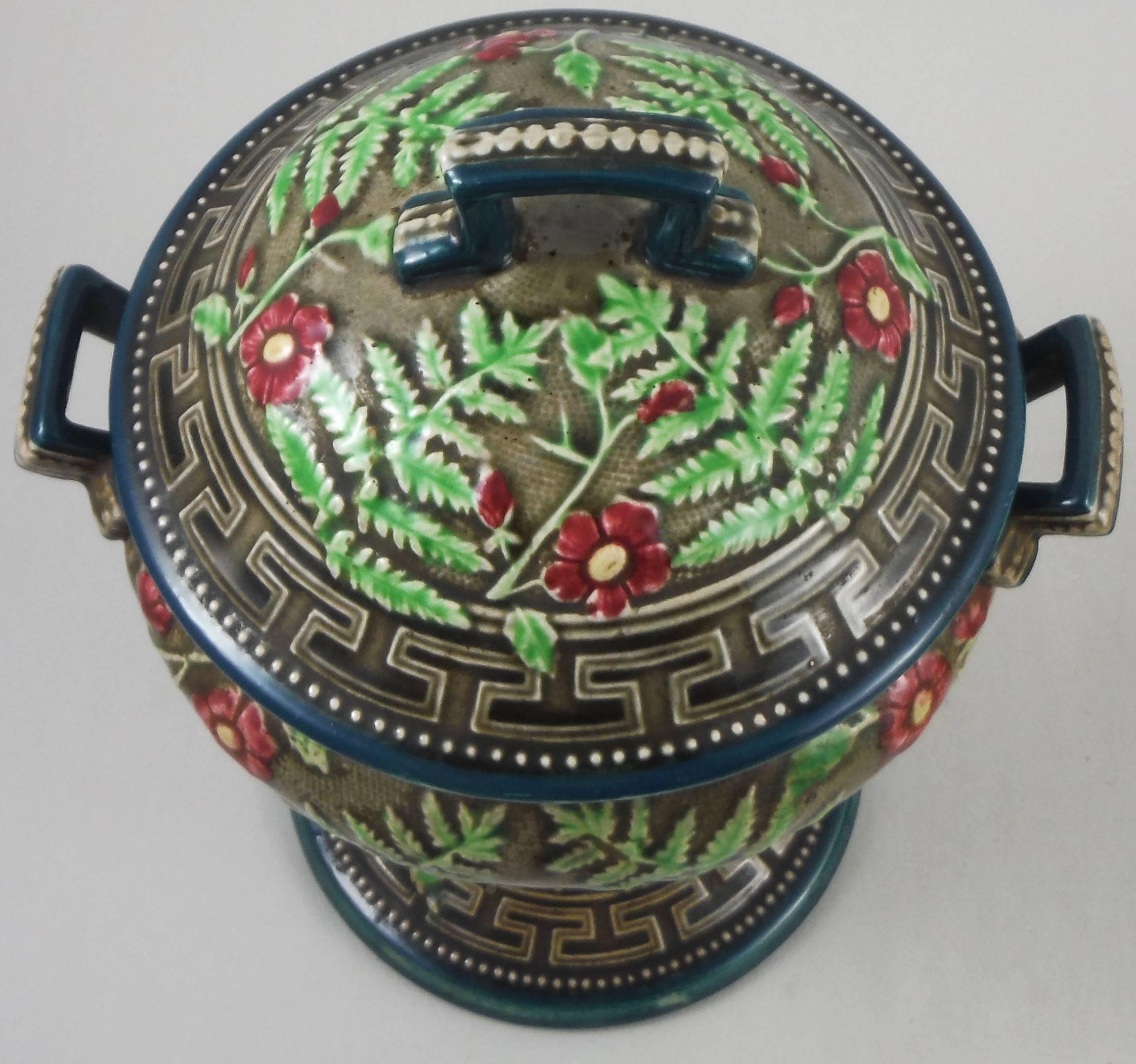 Unusual 19th century Majolica tall lidded footed bowl signed Choisy le Roi.
Usually found in brown background, the dark grey bowl is decorated with ferns leaves and red flowers, Greek key borders.