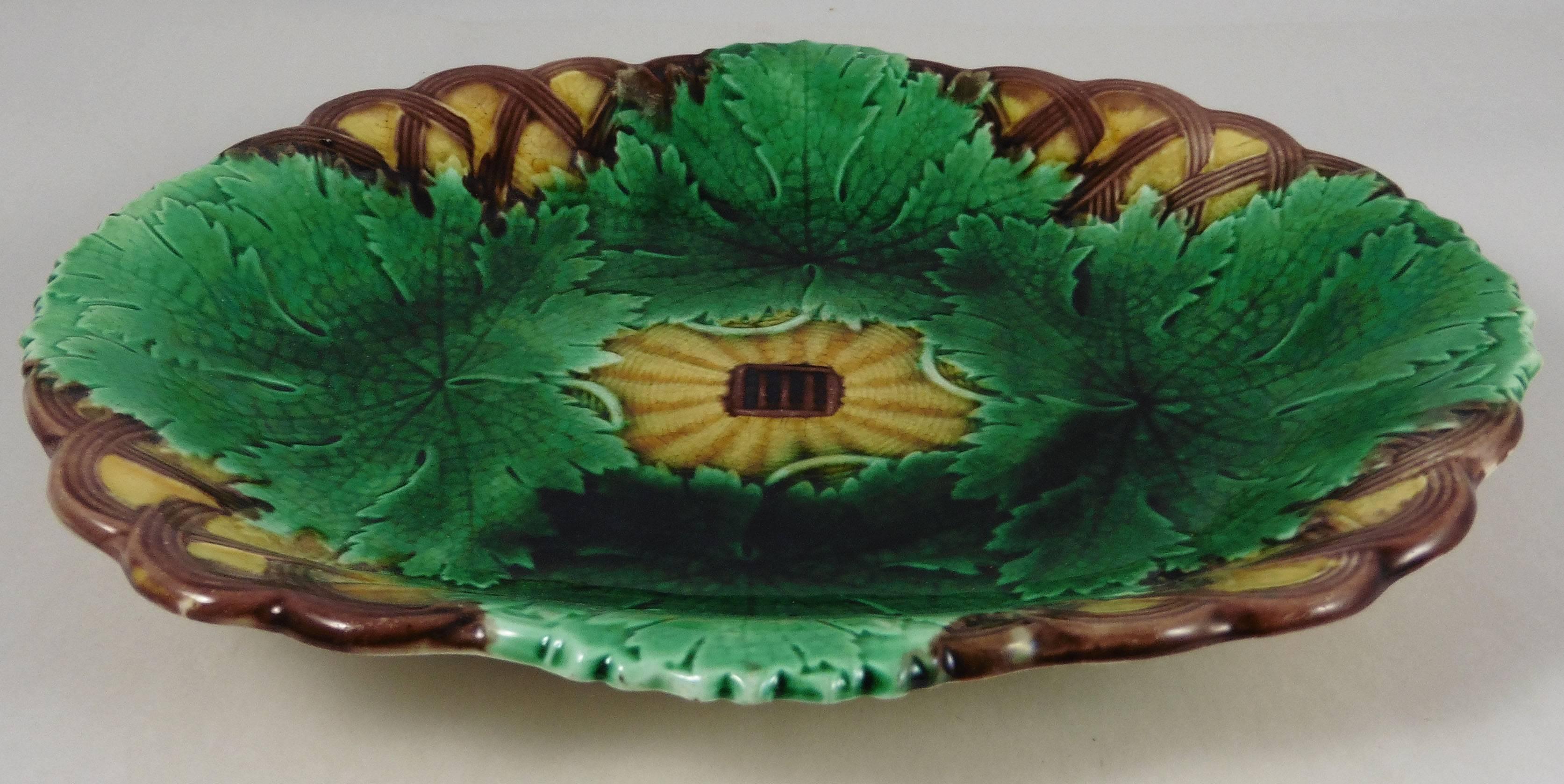 19th century Majolica leaves on a basketweave platter signed Wedgwood.