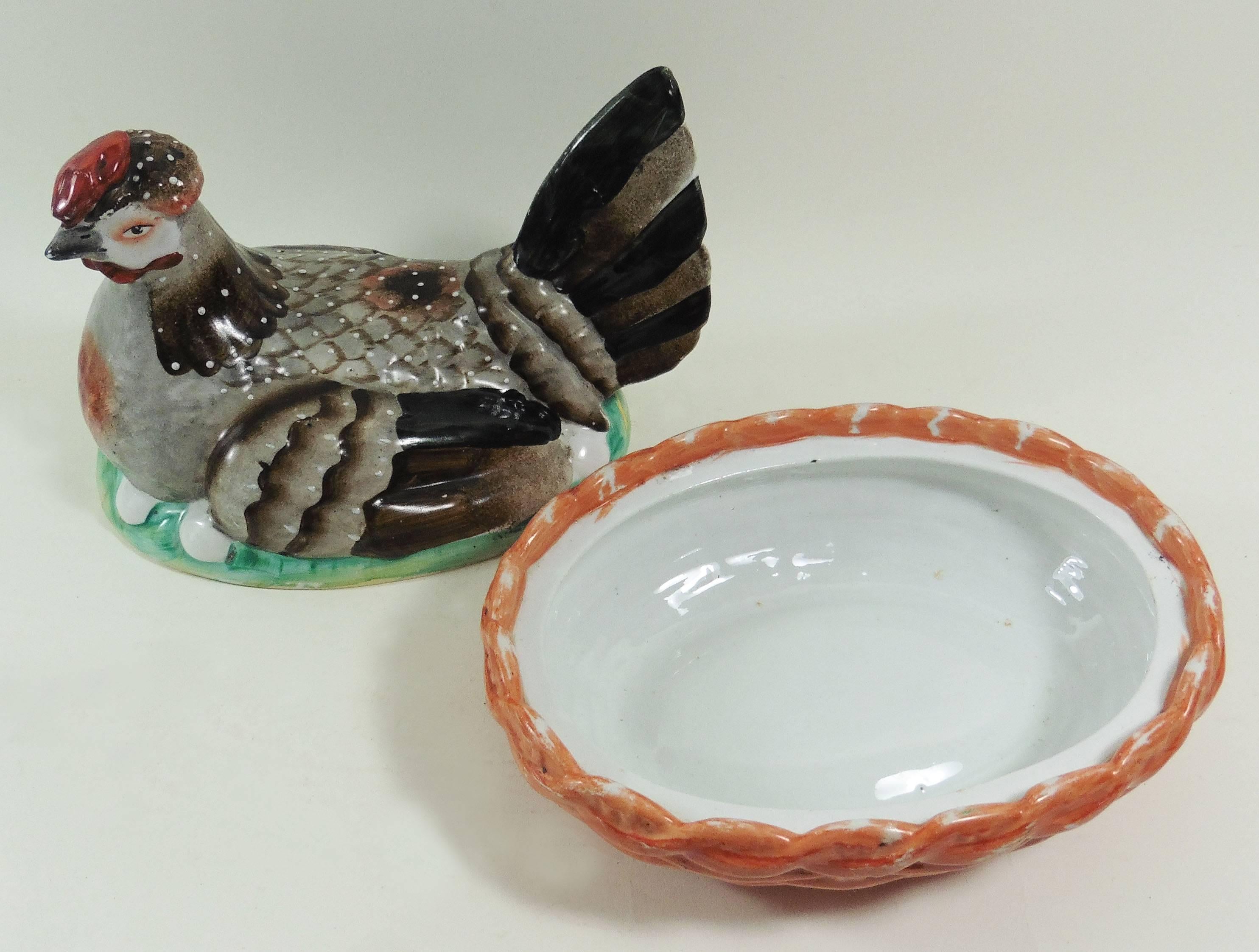 Colorful 19th century Staffordshire hen on nest tureen with orange basket.
Minors wears.