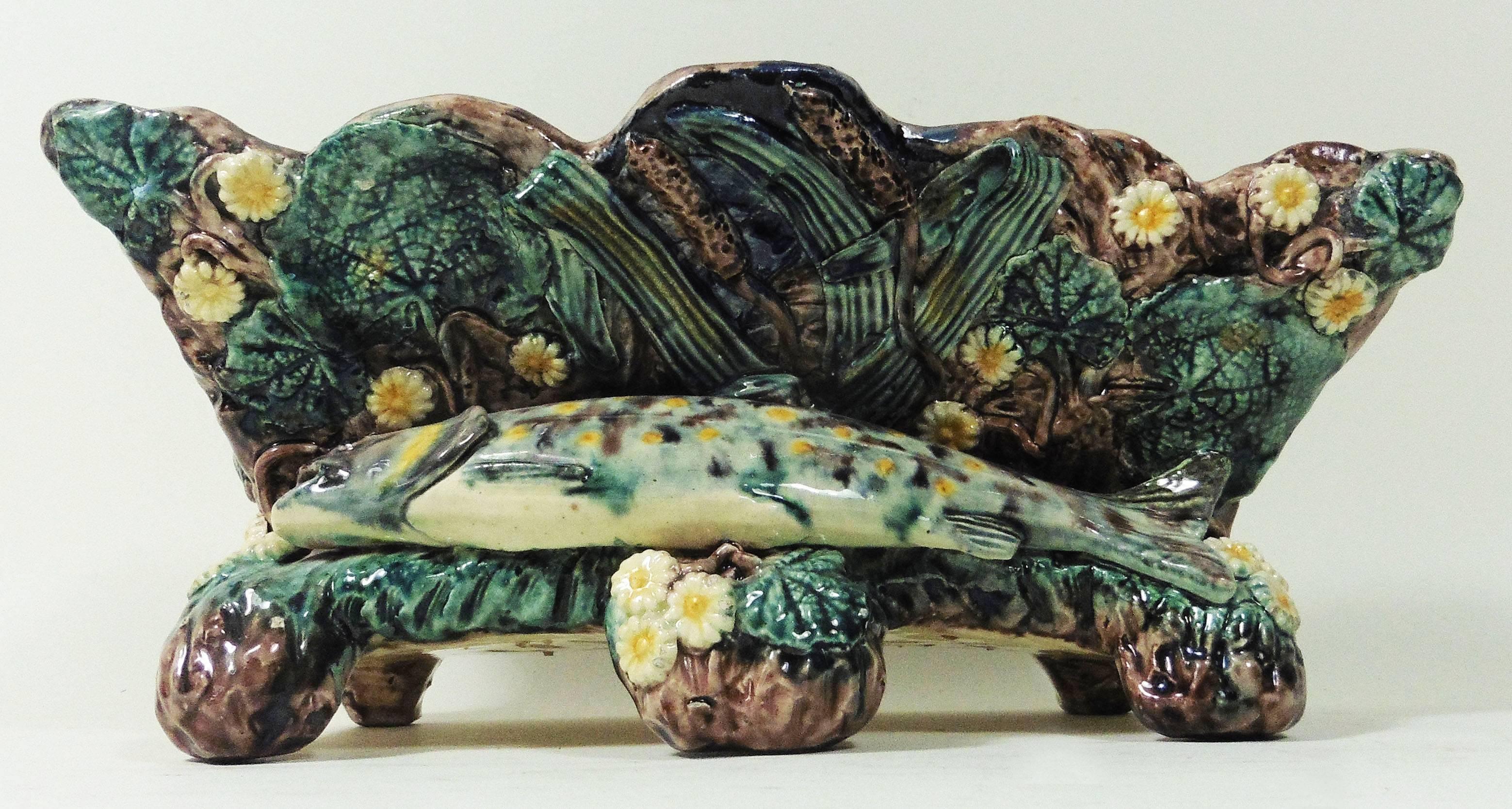 19th century Palissy footed wood box jardiniere School of Paris.
A large spotted fish on the front of the jardiniere surrounded by leaves and white daisies.
The School of Paris was composed by makers as Victor Barbizet, Francois Maurice, Thomas
