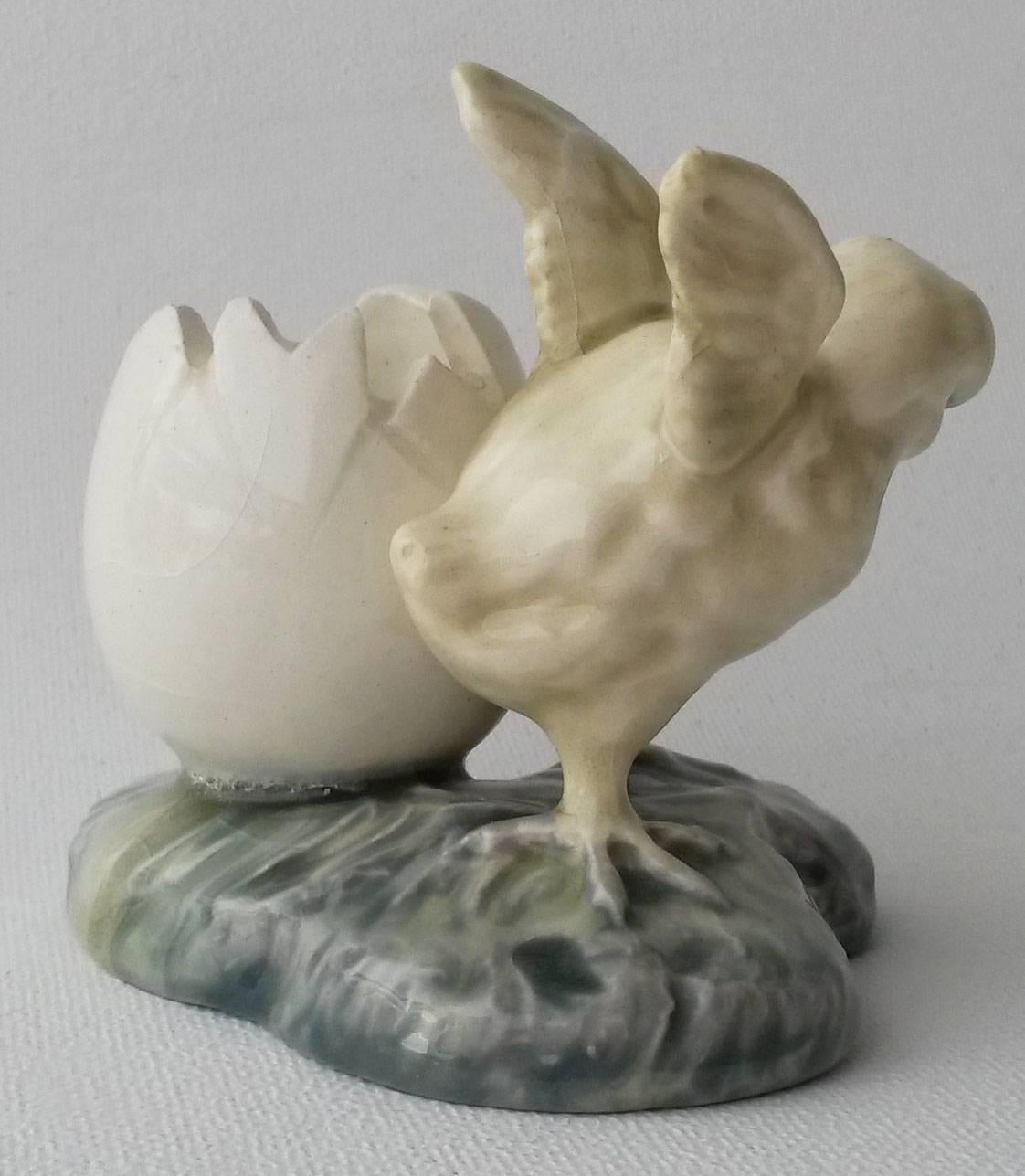 French Majolica vase with a yellow chick against an egg vase, circa 1900. Attributed to Delphin Massier.