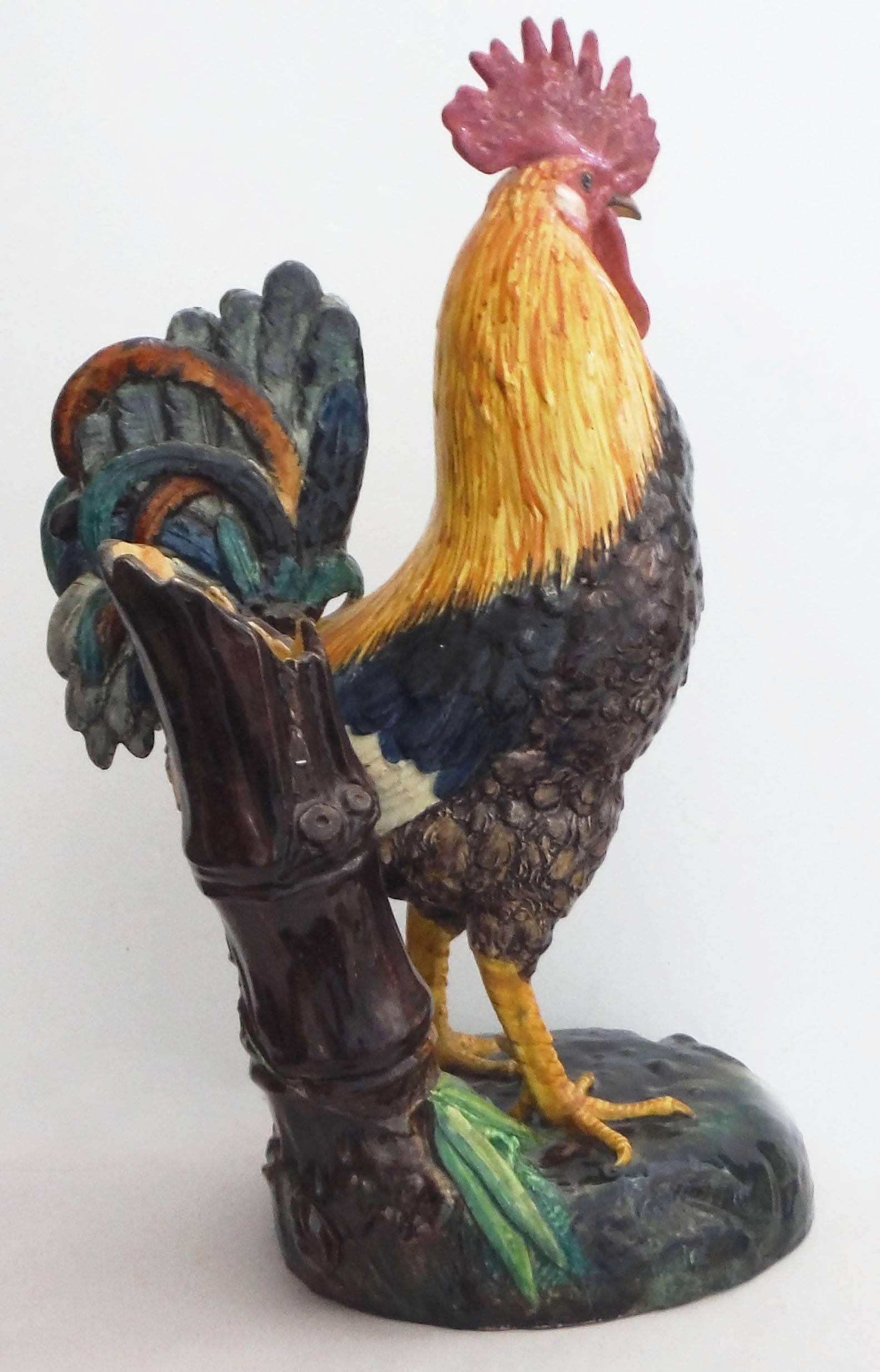 Large Majolica colorful rooster signed Delphin Massier circa 1890.
On the back of the rooster, a rare brown bamboo vase, usually the vase is a trunk.
