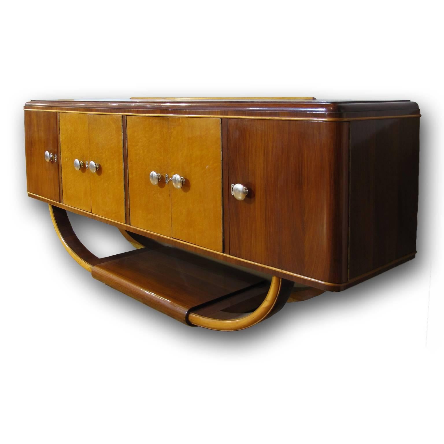 A spectacular Italian Art Deco four-door buffet or credenza in palisander with center doors in maple wood.
Simple hardware that complements the curved design.
 
 