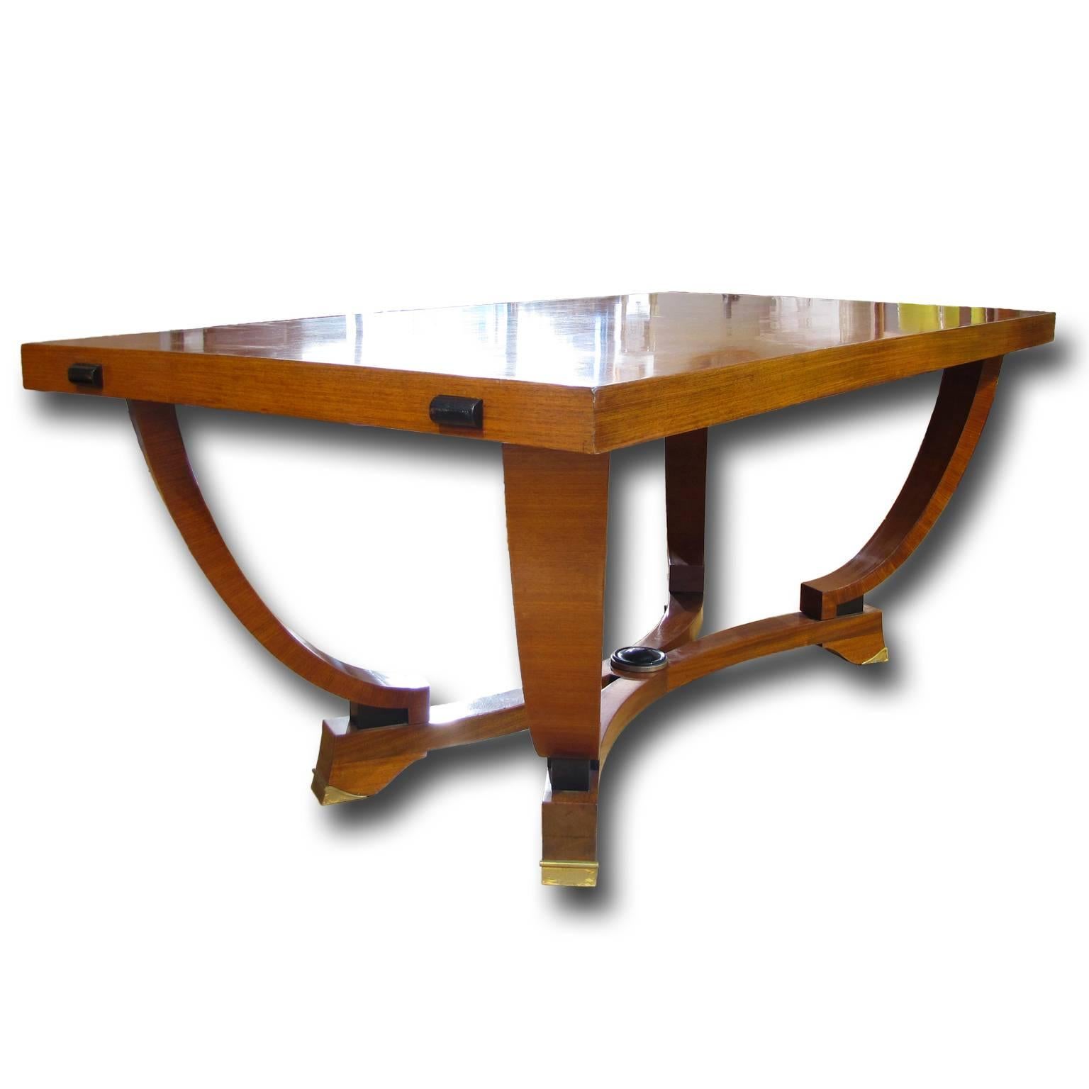 An Italian Art Deco dining table with unique design from circa 1930, walnut veneered and polished with spirits.
The wide rectangular tabletop is displaying a beautiful walnut grain. It is supported by four curved legs that are connected to the wide