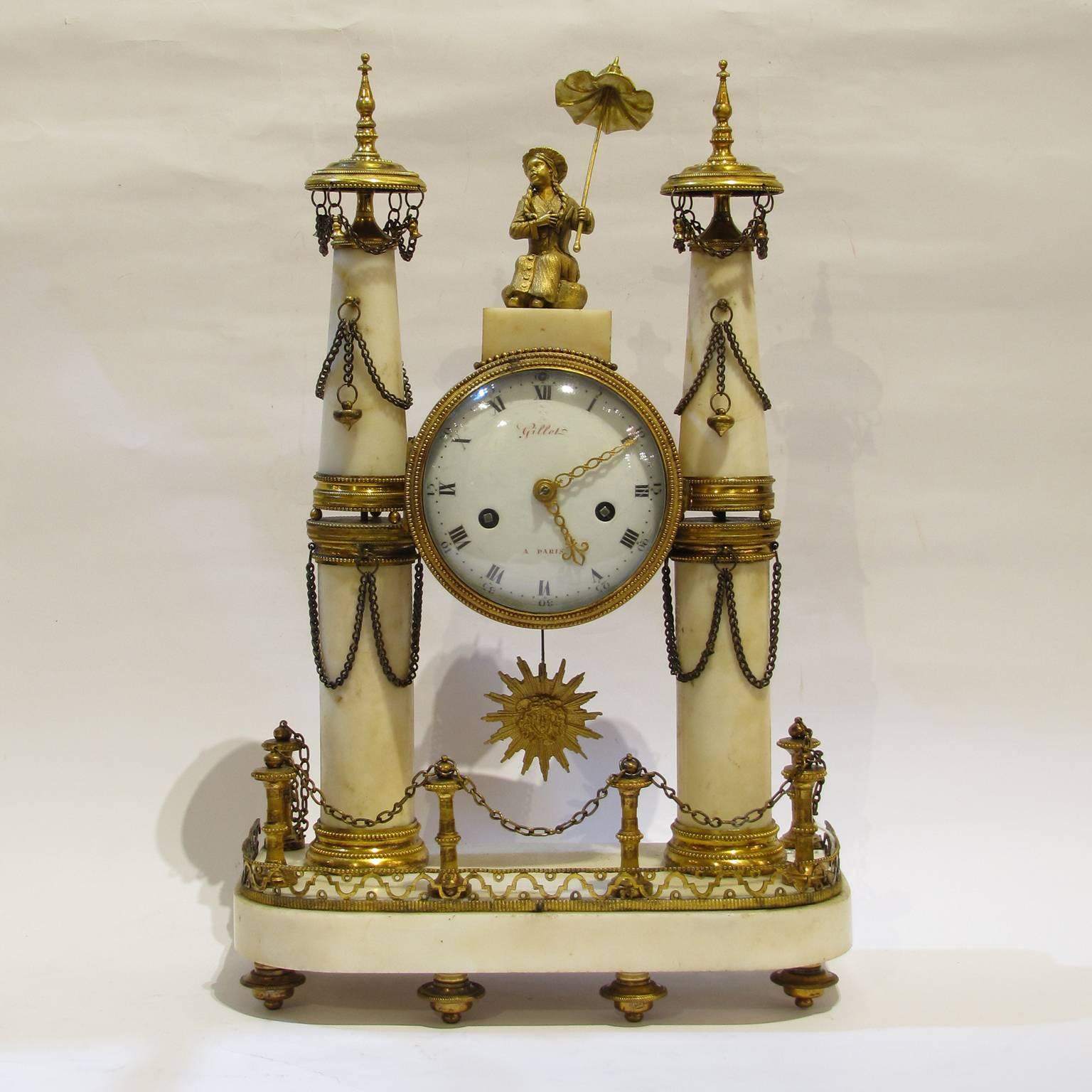 A superb pair Louis XVI ormolu-mounted and white Carrara marble mantel clocks with sunburst pendulum. Round marble columns on each side are supporting the cylindrical movement casing. The clocks do have a seven-day movement with anchor escapement,