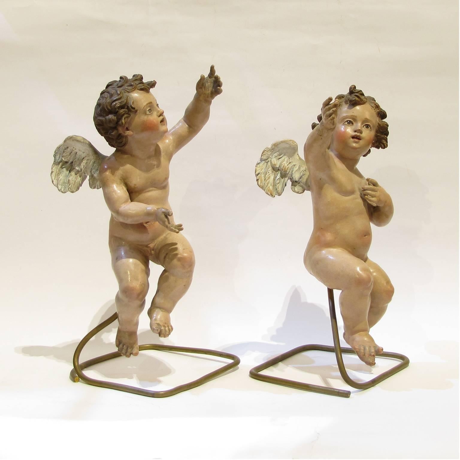 A beautiful pair of sculptures of young angels in polychrome terracotta. Neapolitan manufactory from the early 18th century.