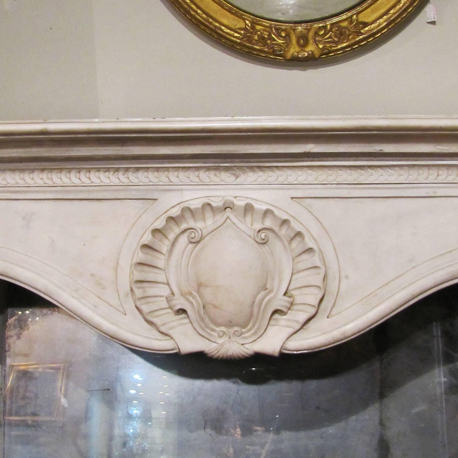 A large Louis XV fireplace in beautifully sculpted white Carrara marble. 
Italian manufactory from the 19th century.