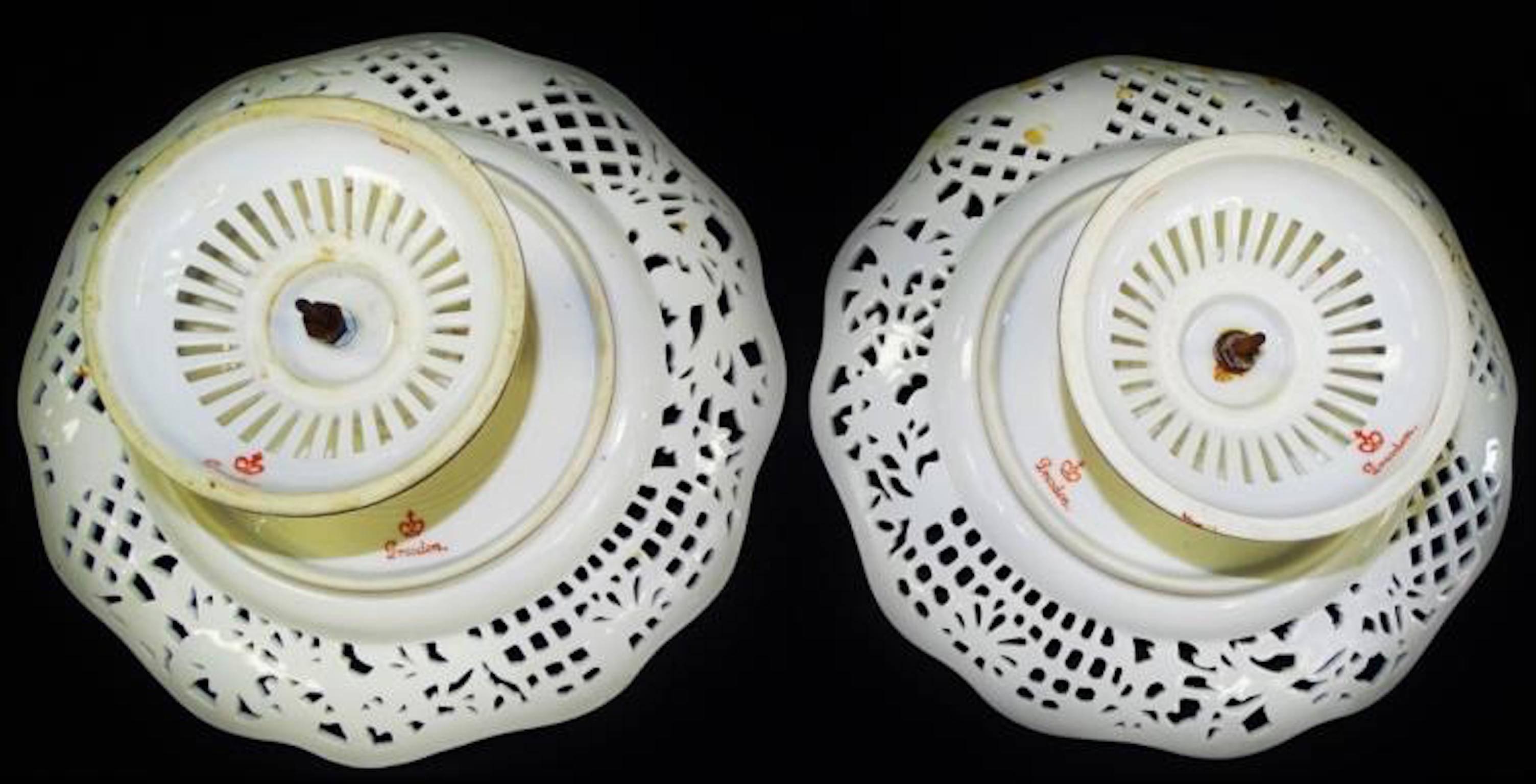 Pair of two 19th century Dresden-Meissen German porcelain cake stands or tazzas. Both with heavily reticulated borders and base. Hand-painted florals and gilt embellished reticulation. Both stamped with RK Crown and impressed Meissen mark.