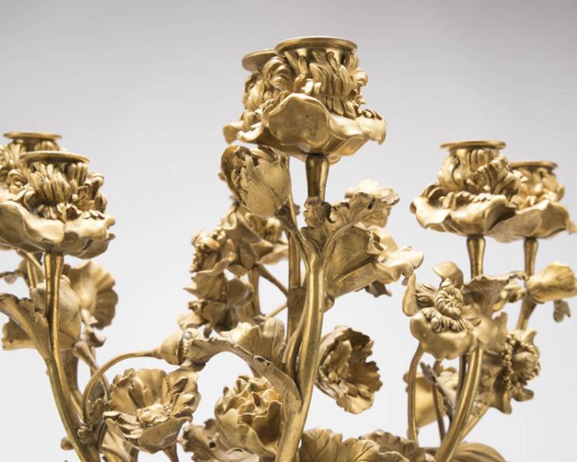 Signed and dated to base ''Henry Dasson 1885'' for maker Henri Dasson (1825-1896 French), gilt bronze, surmounted by seven naturalistic poppy stems terminating in floriform lights, issuing from an urn-form grape vine-festooned body raised on