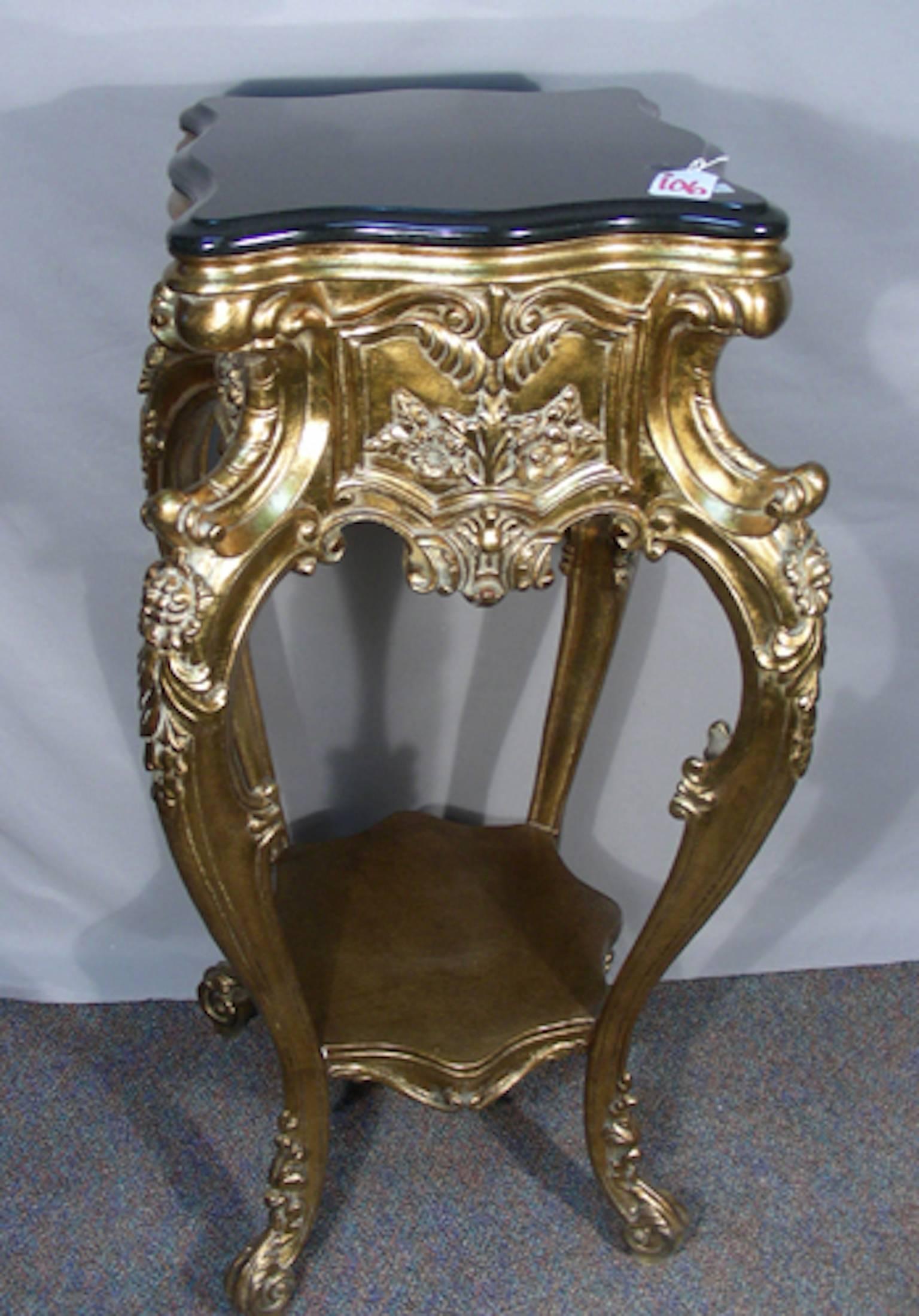 A beautiful carved pedestal with ornate carving and black marble-top. Measures: 45 1/2