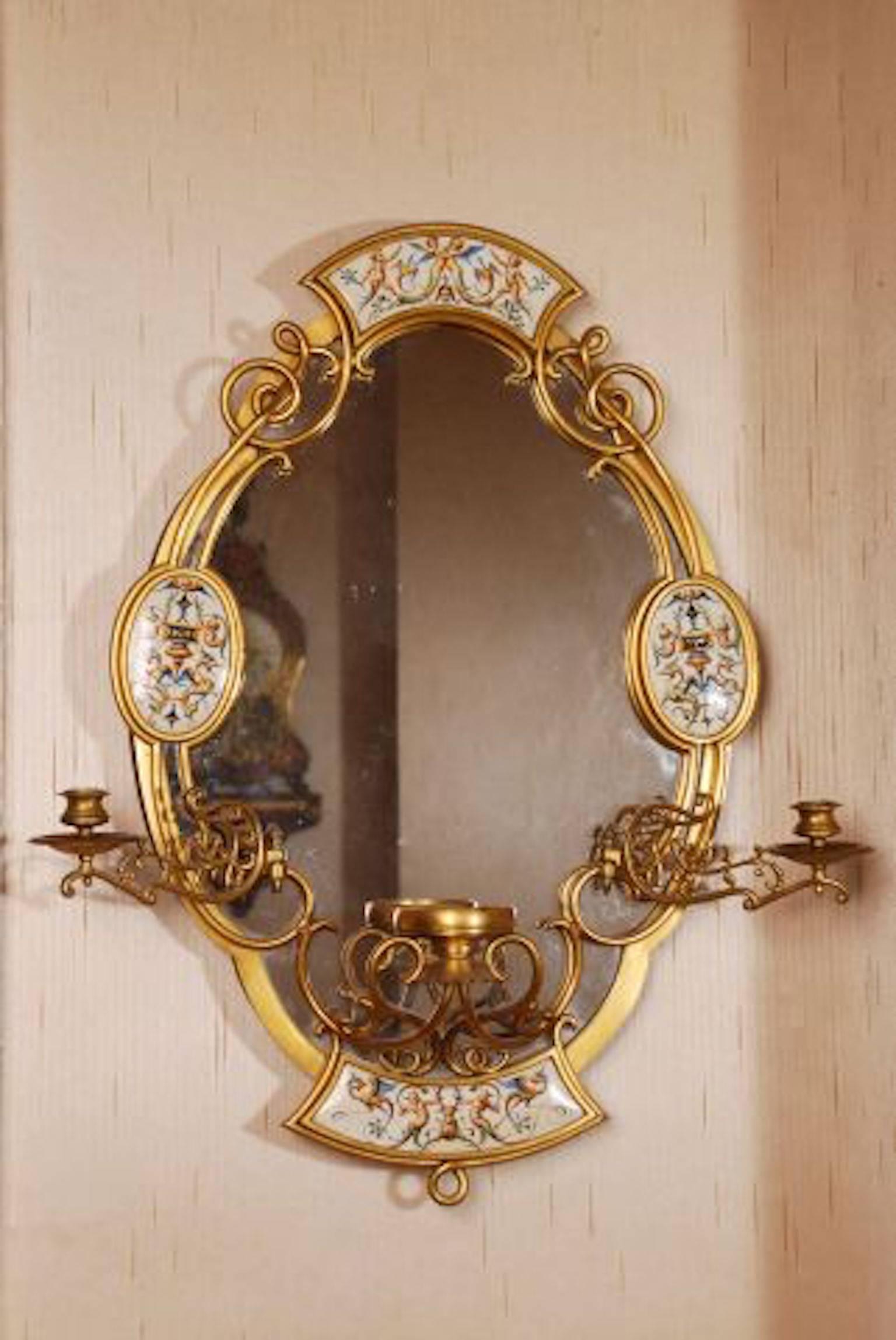 19th century Victorian aesthetic gilt bronze German porcelain mirror
inset with soft paste plaques depicting mythological creatures, with a German porcelain figure of a maiden on shelf, and girandole candle arms. 28