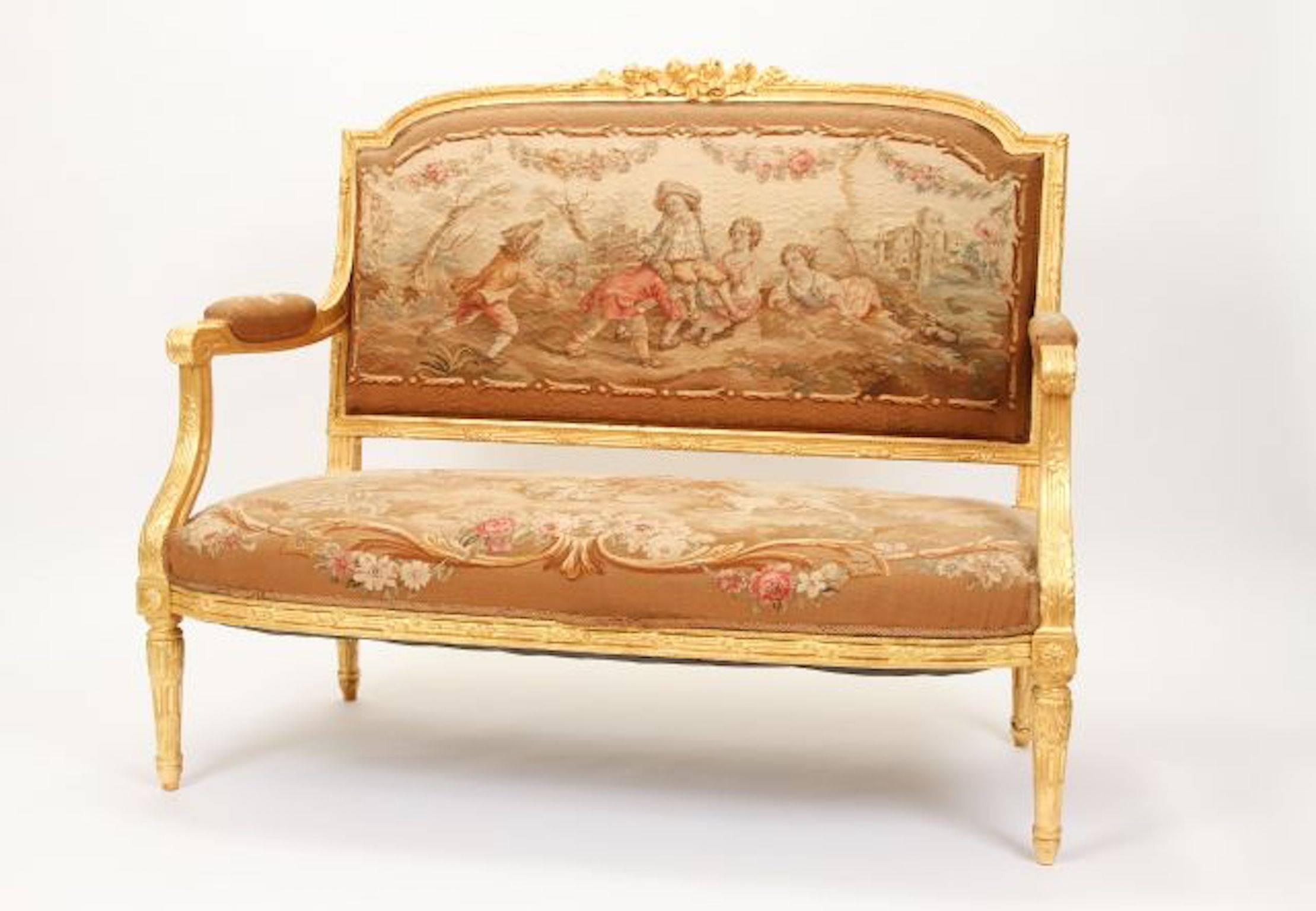 19th century  Louis XVI settee in giltwood with Aubusson tapestry of children at play and animals. Hand carved wood frame wiith excellent accenst and scroll Measures: 41" H x 50" W x 21" D.