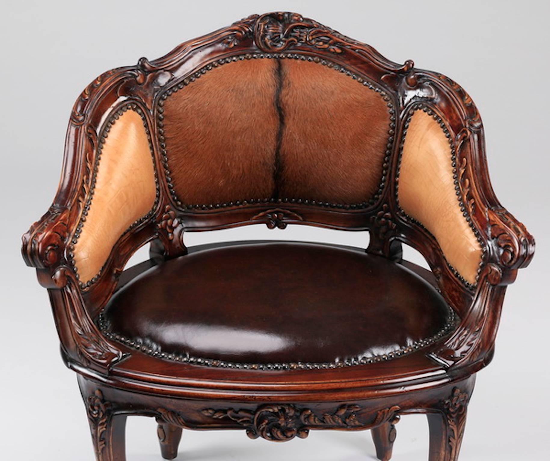 Contemporary Louis XV style petite bergere, the backrest upholstered in hair on hide, the sides and seat in faux leather with nailhead trim, the carved frame and armrests with acanthus scroll motif, above the apron with central shell cartouche, the