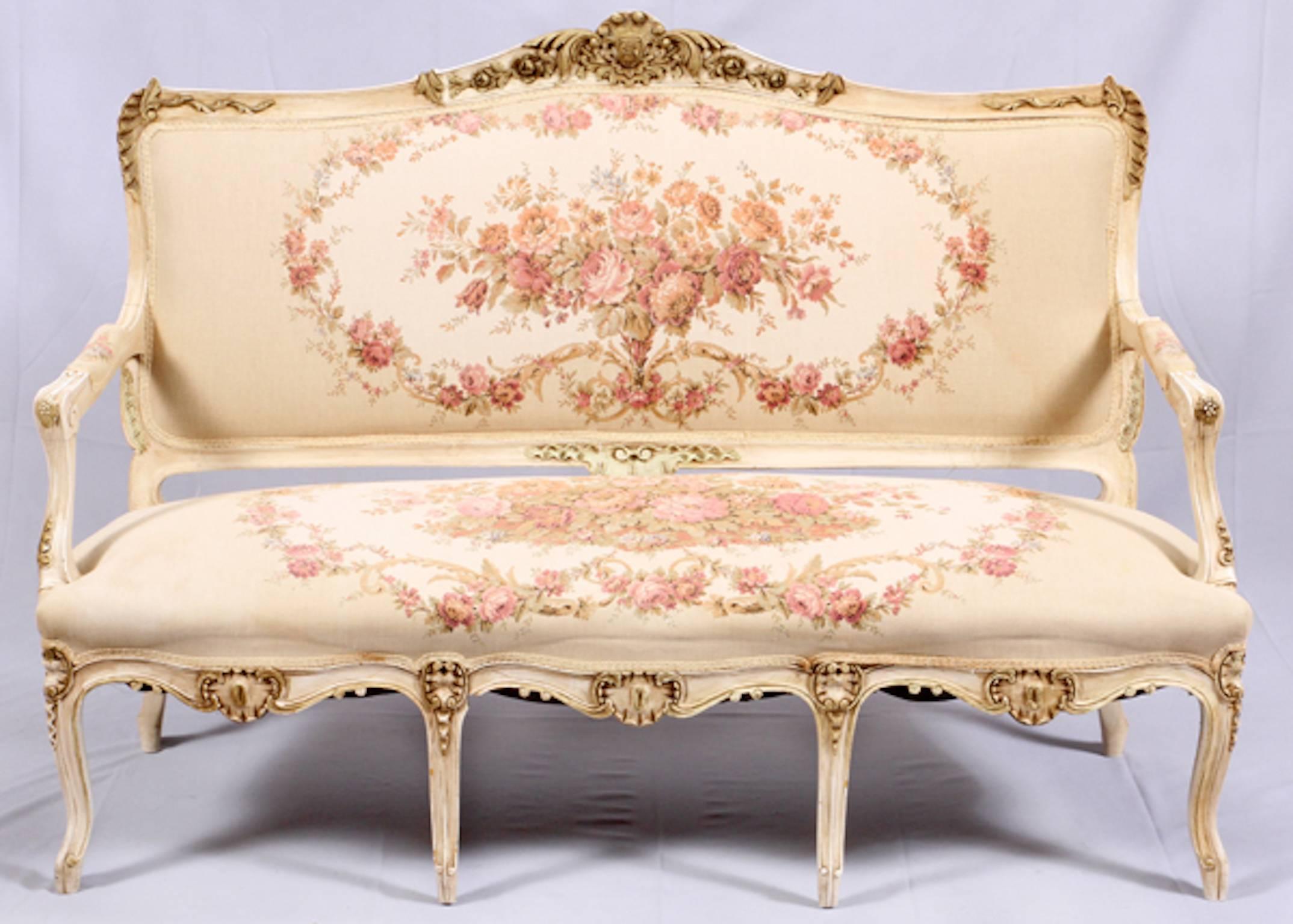 French Louis XV settee and side chairs, three pieces French sofa and side chairs having tapestry upholstery with pink floral medallions on the seats and back cushions. Carved crests with acanthus leaf designs on the frames on all three pieces. Sofa