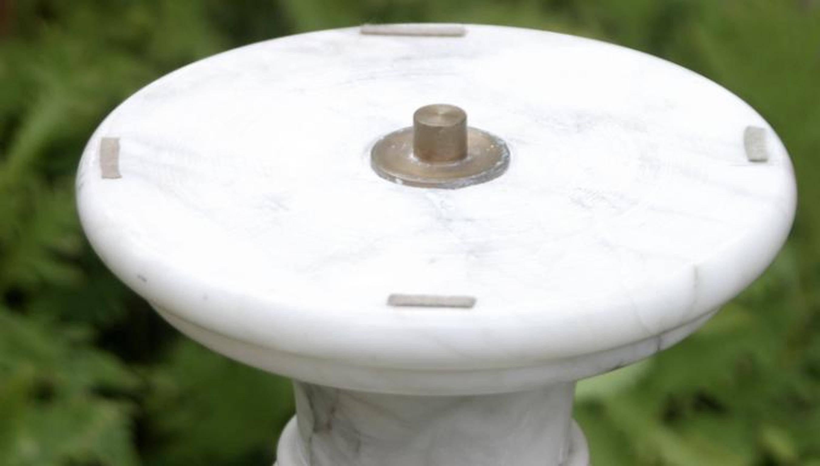 White and gray variegated veined pedestal, octagonal foot, round top with inserted brass pin (for securing bust or statue), no maker's mark.
