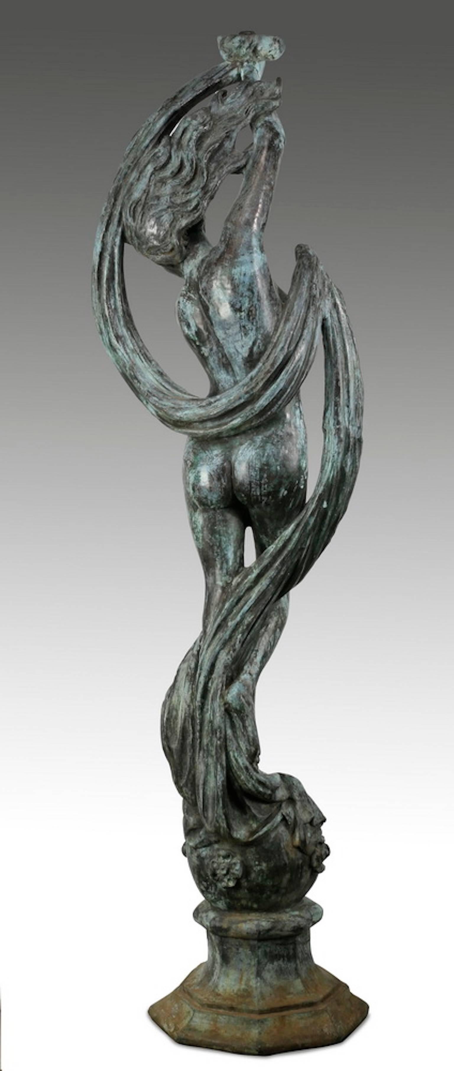 Bronze figural sculpture, in the style of Jean-Louis Gregoire (French 1840-1890), depicting a nude maiden standing on a ball with her arms raised above her head holding a sash, the whole resting on an octagon shaped base.