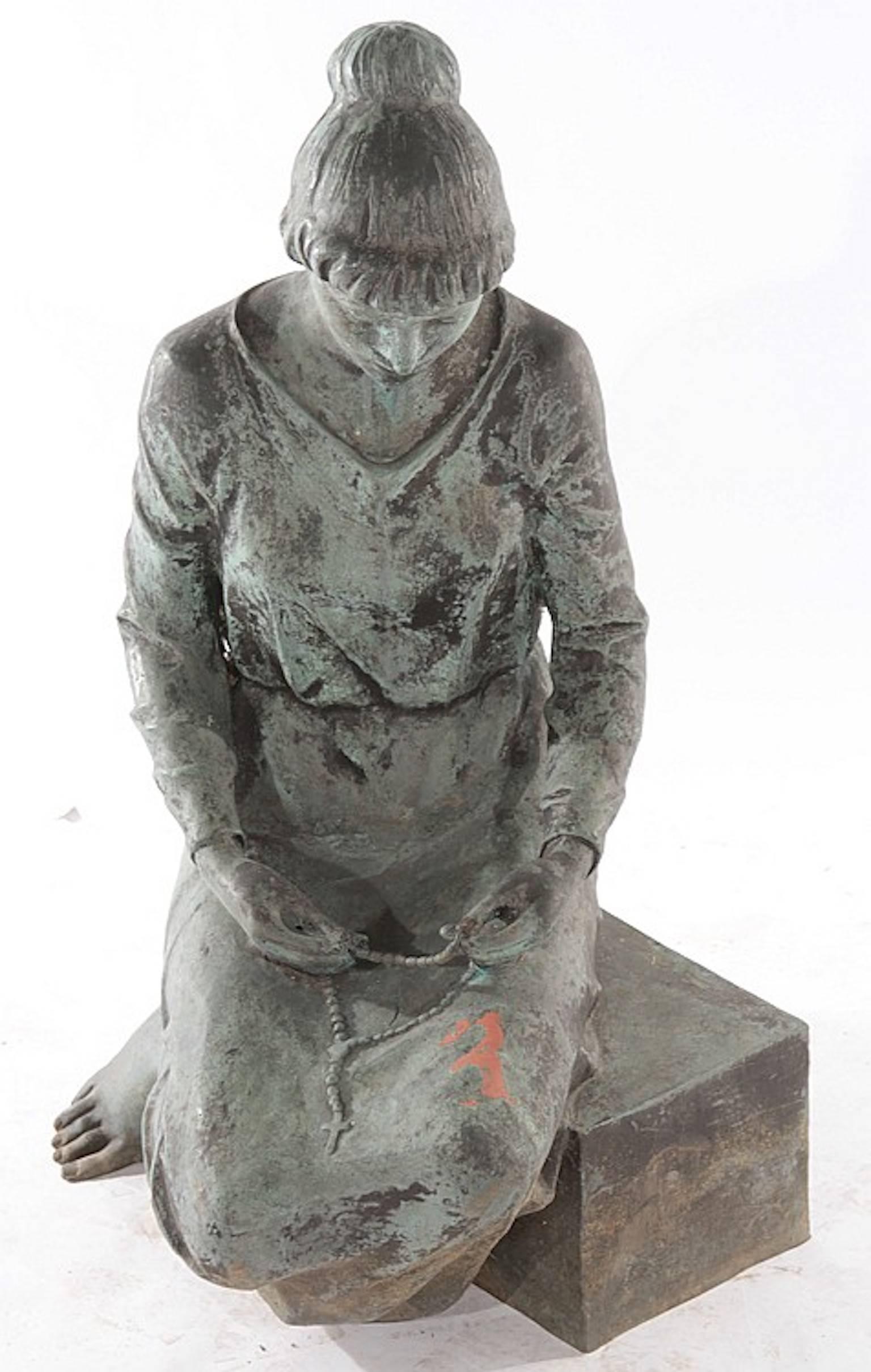 A life sized bronze kneeling woman dressed in simple gown and holding rosary beads, signed 'Steffenini'.