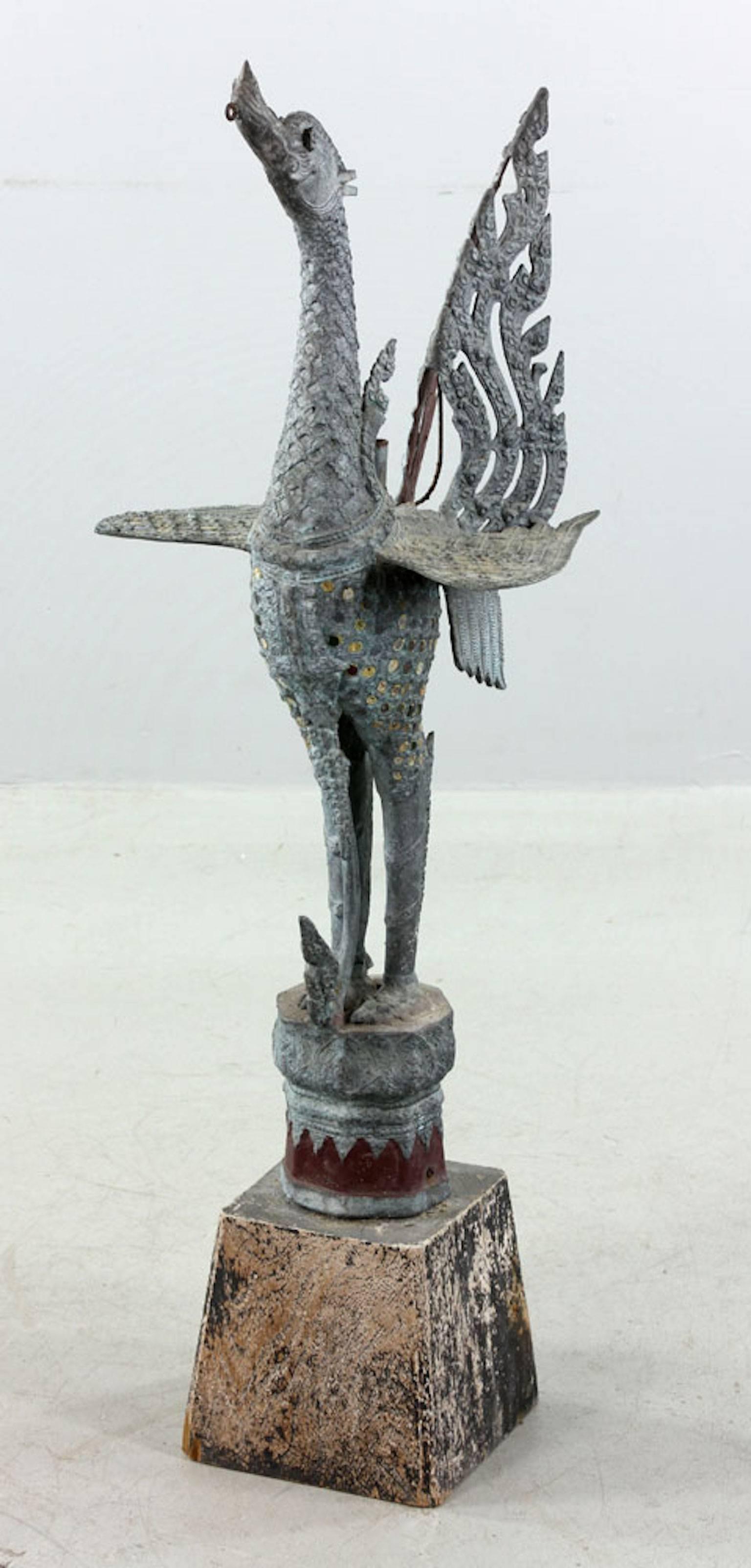 Antique Indonesian bird sculpture, bronze, on wood base. Measures: 42