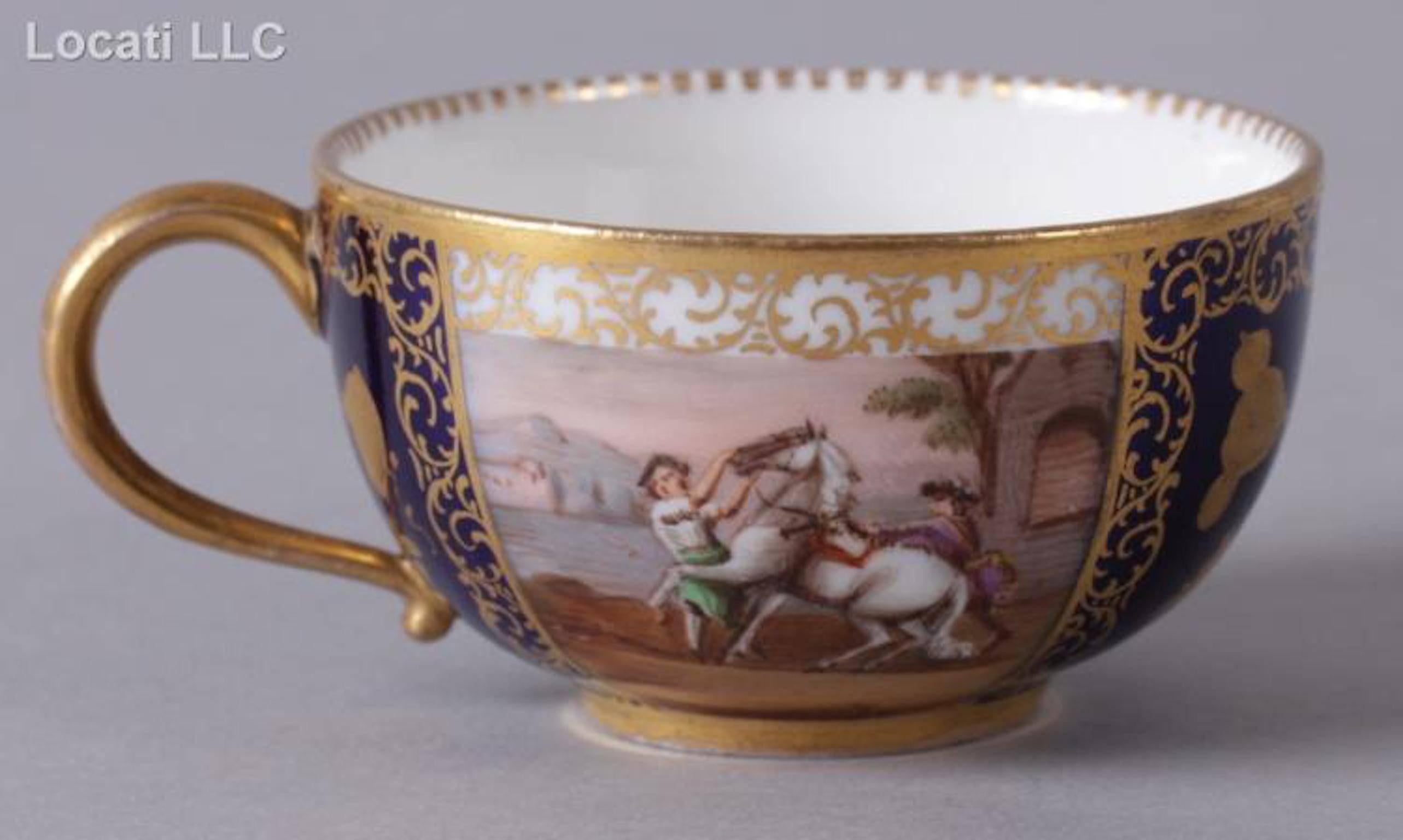 Each piece with hand-painted alternating panels of gilt floral decoration on a cobalt ground and hand-painted scenes of figures and horses.
The saucers are 5 5/8in diameter, the cups are 4in W x 3 1/4in D x 1 3/4in H.
