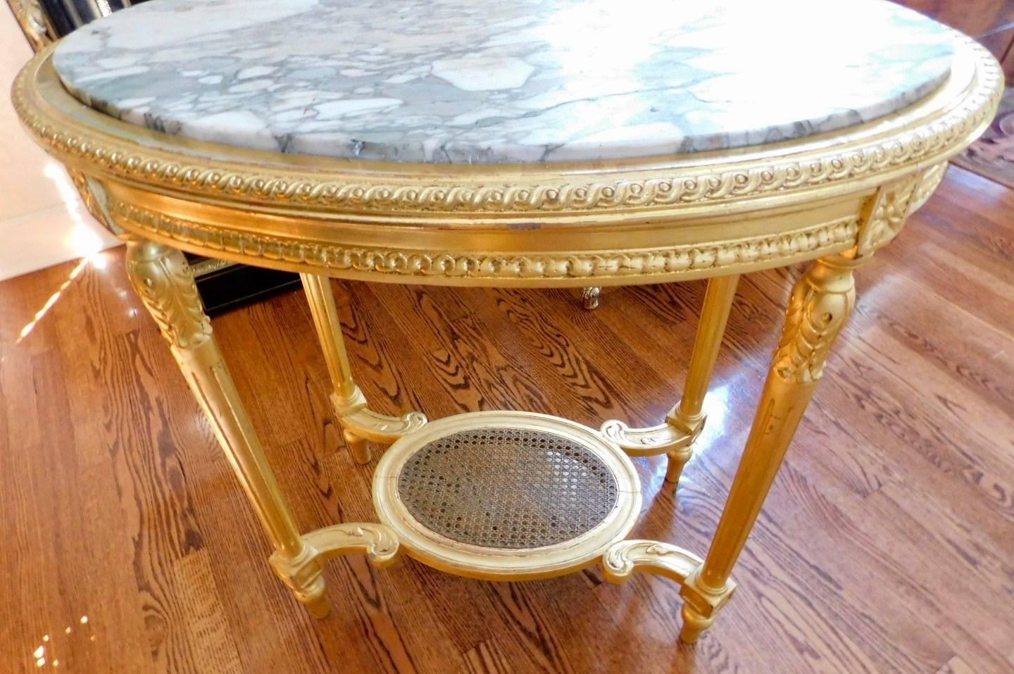 19th century Louis XVI style oval giltwood center table with marble top.