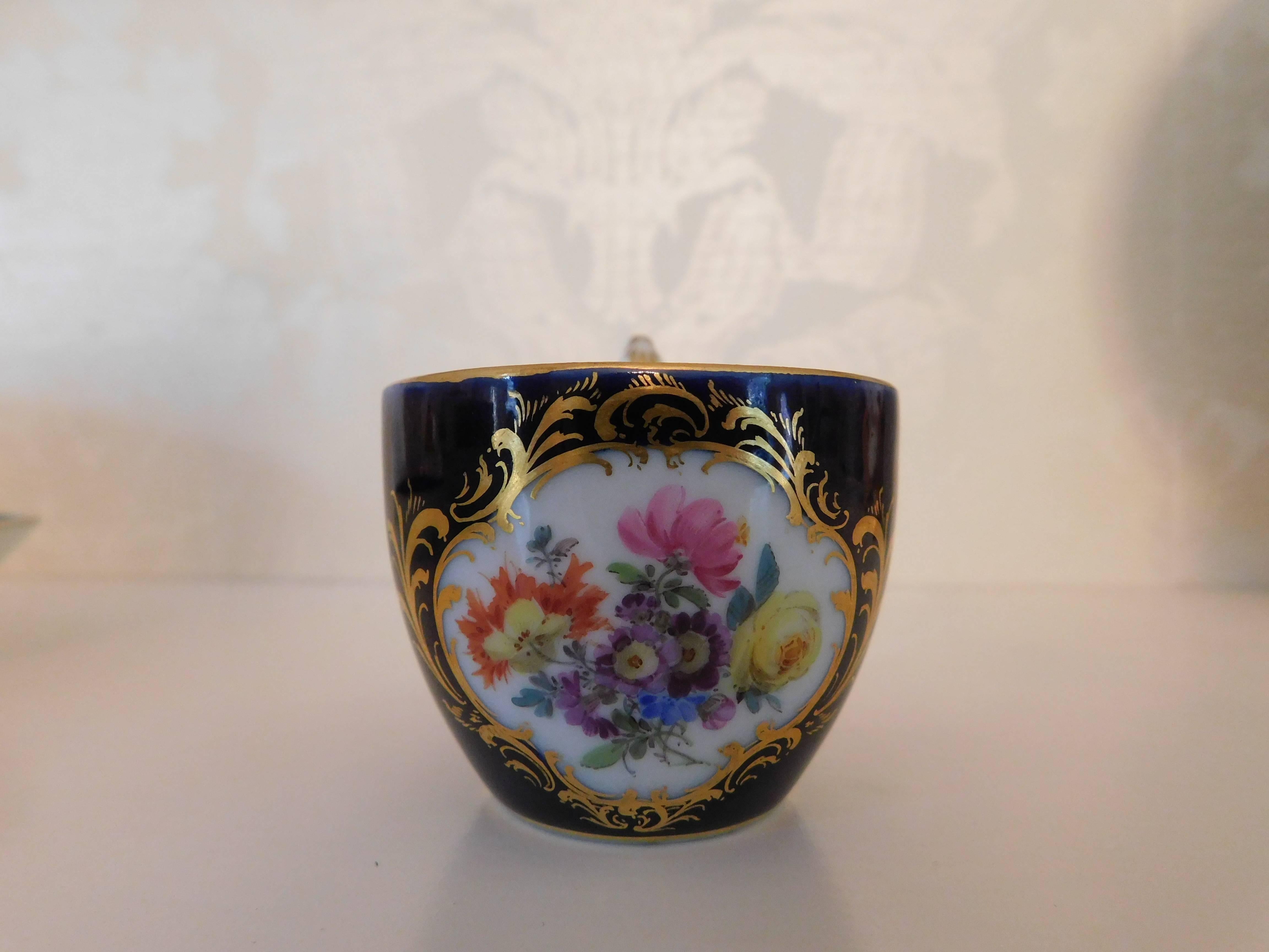 Meissen porcelain cobalt blue and floral cup and saucer.

Measurement in inches:
Cup 2 D x 1.75 H
Saucer 4.5 D x 1 H.