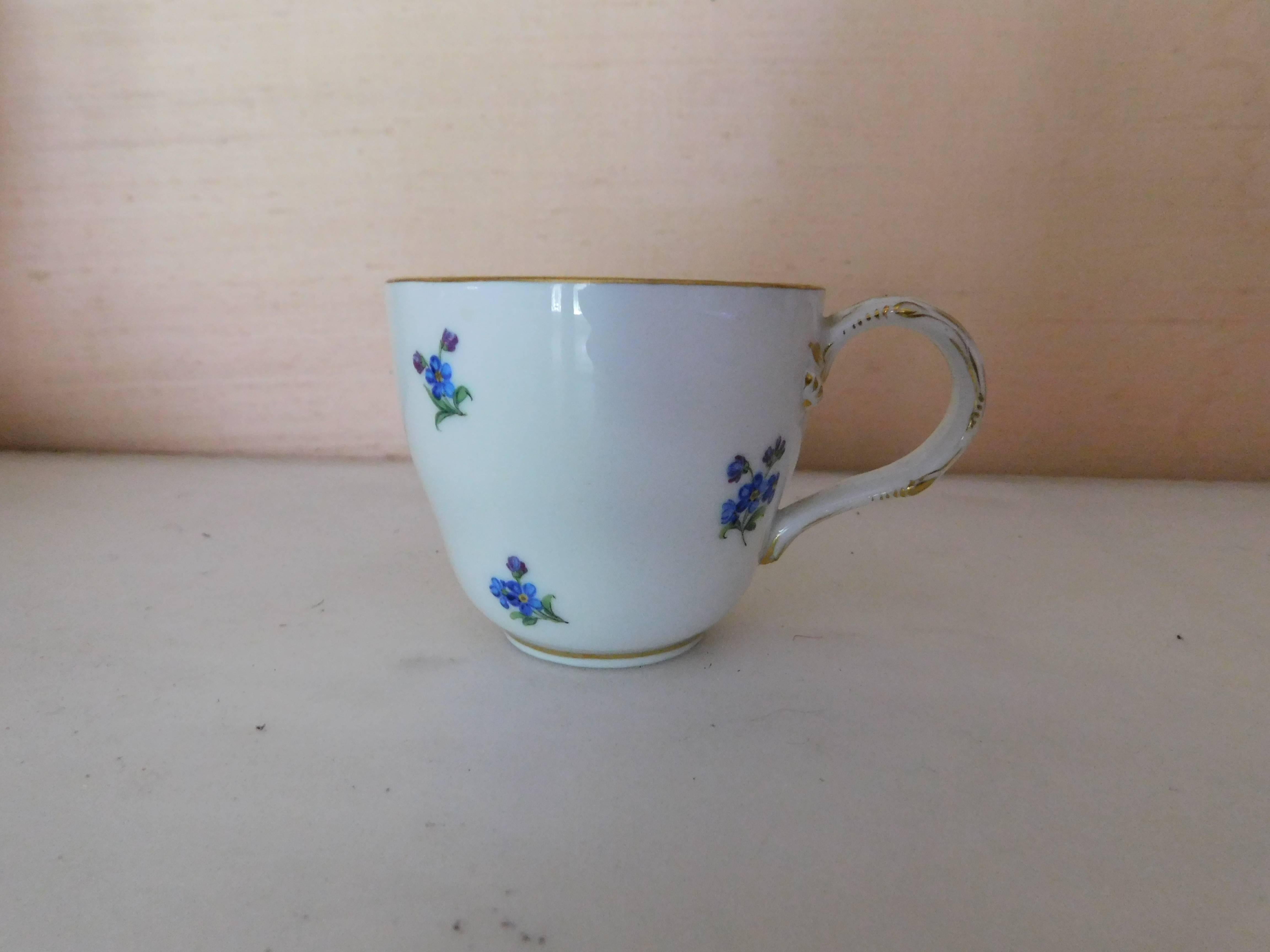 Early 19th century Meissen porcelain blue flower demitasse cup and saucer with
tree handle gold trim.