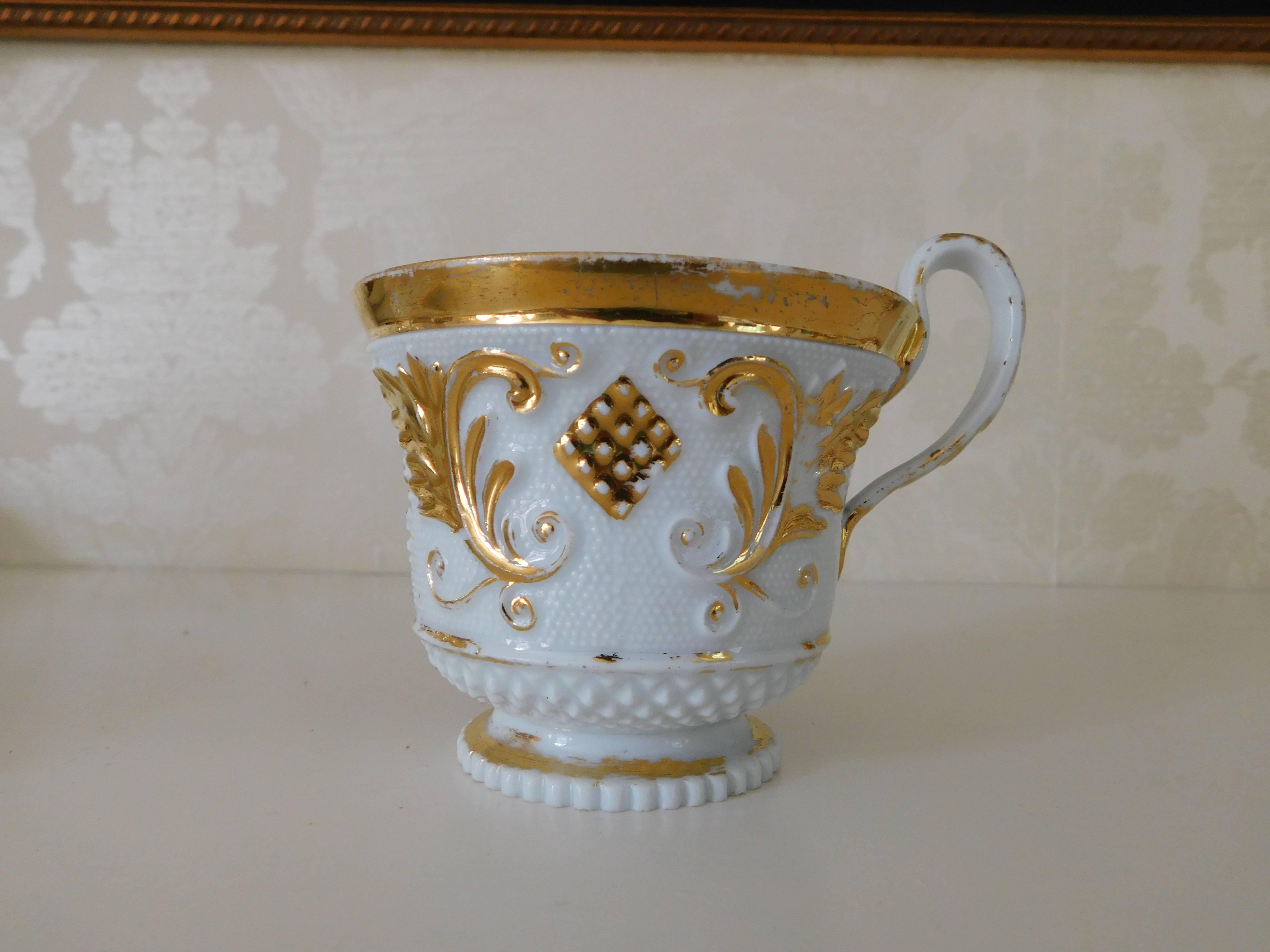 Early 19th century Meissen porcelain cup and saucer white with gold gilt.
Measurements in inches:
Cup 3.5 D x 3 H
Saucer 6 D x 1 H.
 