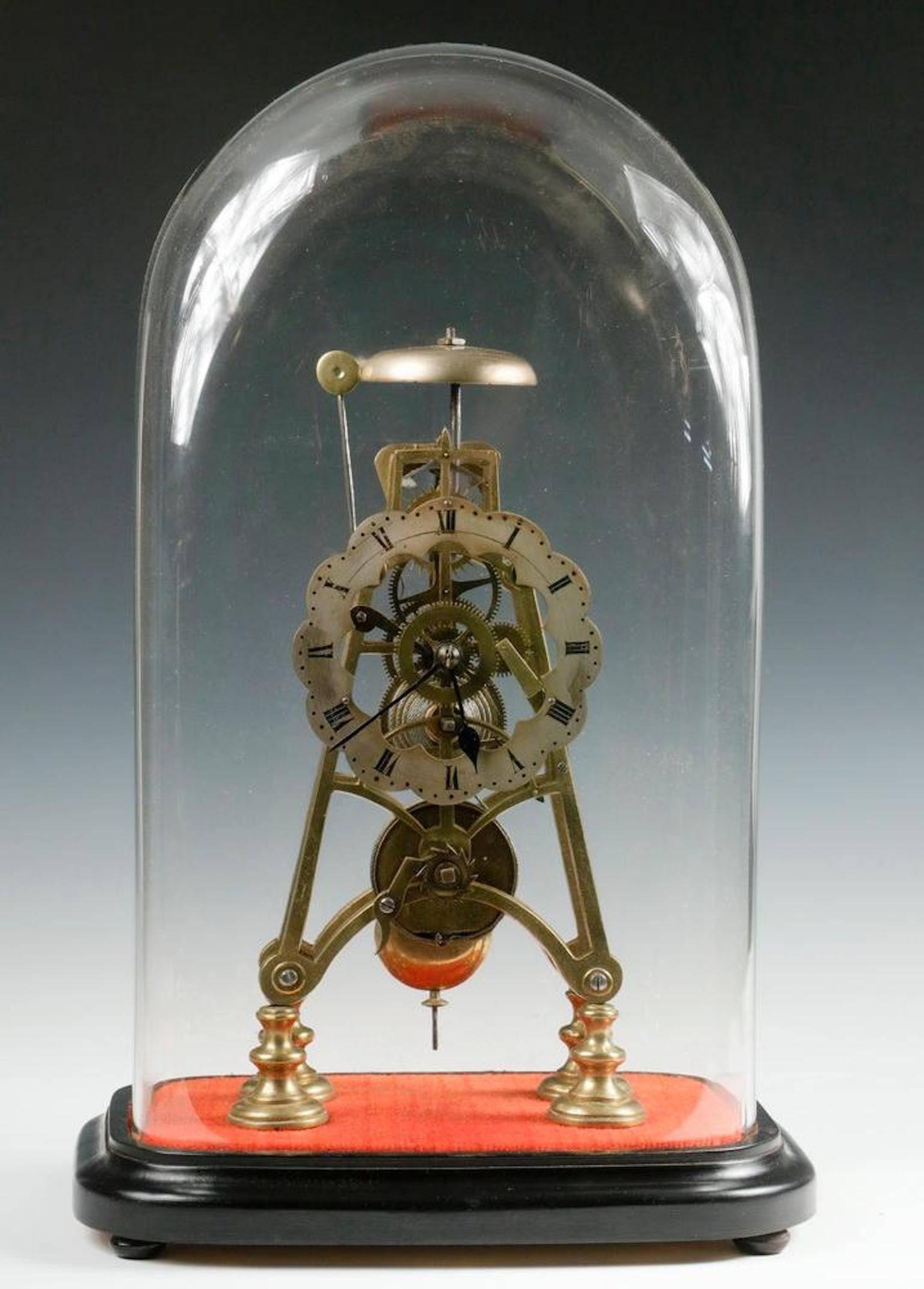 Early Skeleton clock under glass dome, with single train fusee movement, silvered dial, with striking alarm, key and pendulum, brass works and frame, set on ebonized molded wood base.
Clock dimensions: 12 1/2in. high, dome: 19in. high, 11in. x 7