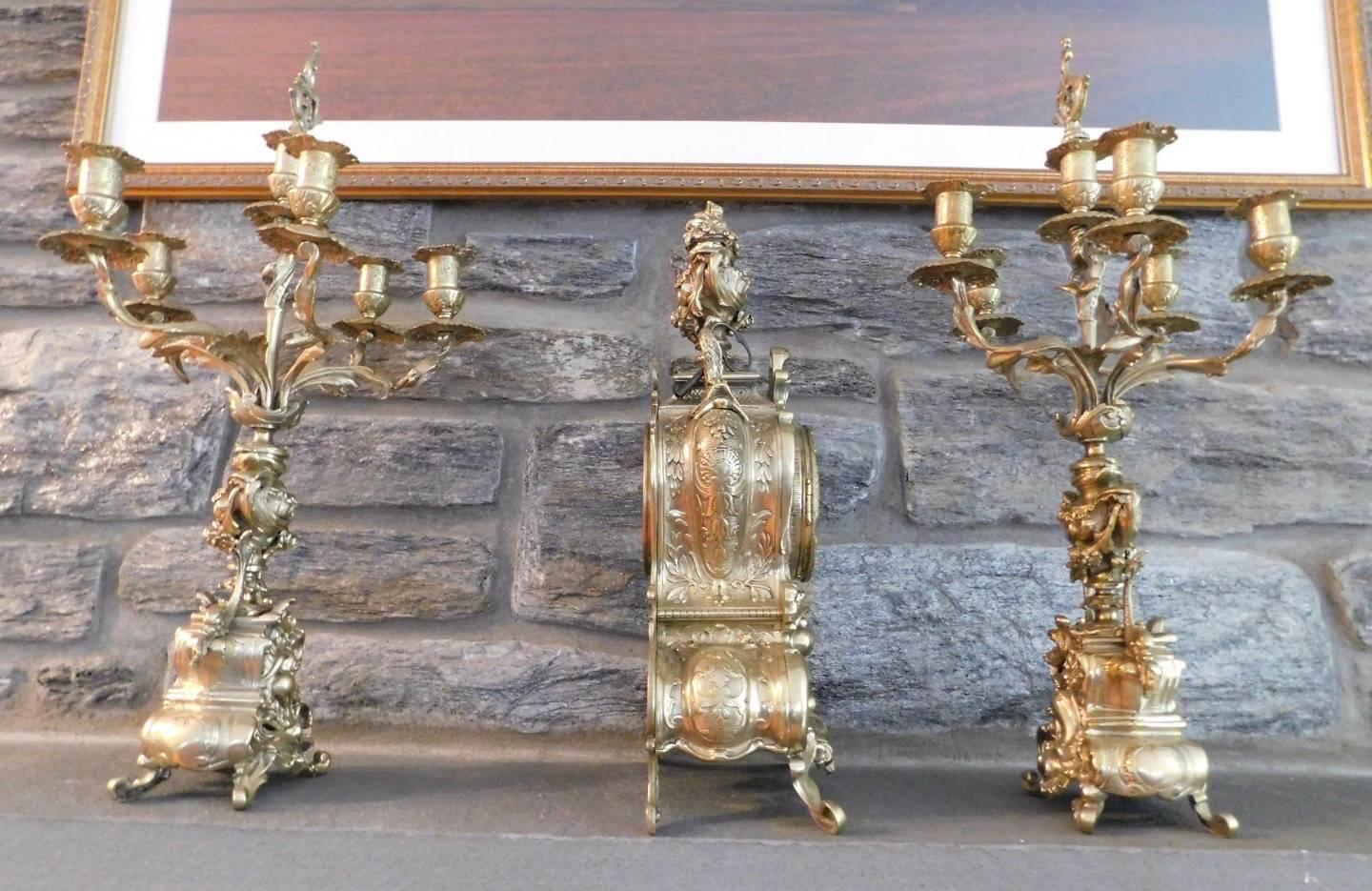 19th century French brass Garniture clock set with candelabras in excellent condition
Clock works
Clock measures in inches: 9 W x 18 H x 5 D
Candelabra measures in inches: 13 D x 23.5 H.