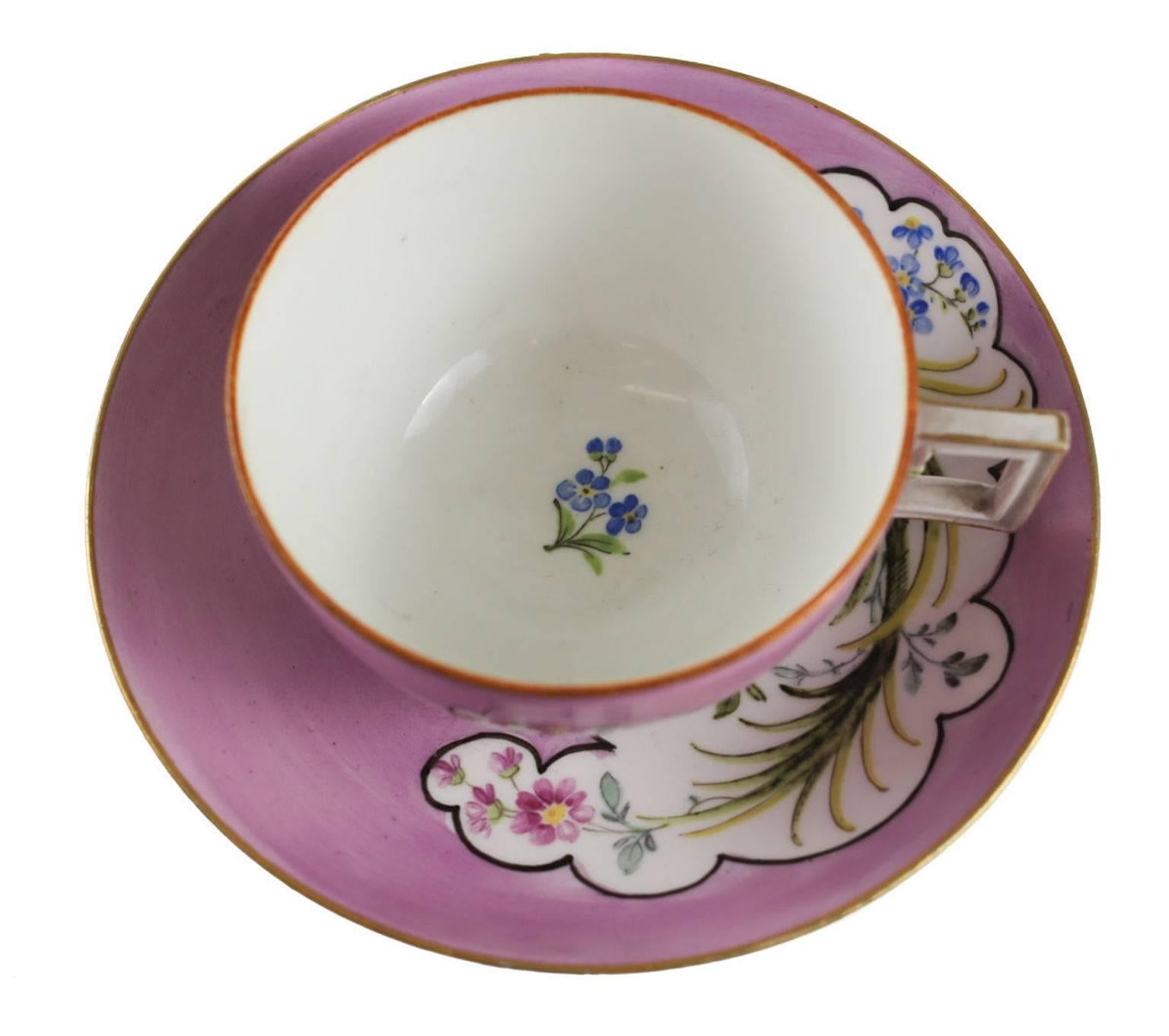 Meissen Germany porcelain cup and saucer, pink rose. Charming pink grounds with hand-painted florals inside a cloud form outlined design. Gilt to the rims. Marked to the underside.
Measures: Approximate, 3 inches, diameter (3.75 with handle) x 1.75
