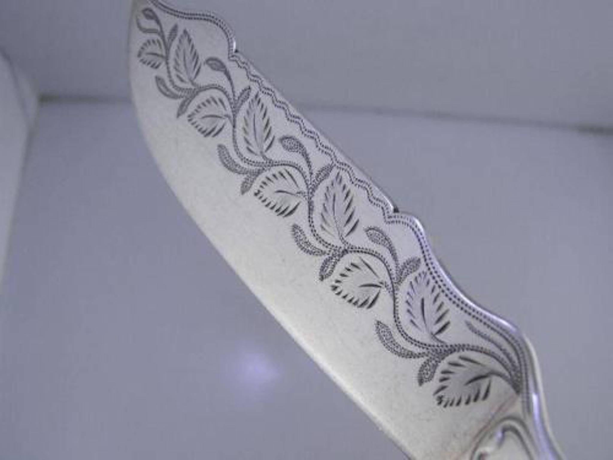 Early coin silver serving knife by R&W Wilson of Philadelphia circa 1825-1846, weighs 1.47 troy ozs.
leaf engraved ~ Coulomb
King / Kings pattern with a engraved blade portion of leaves and vines.