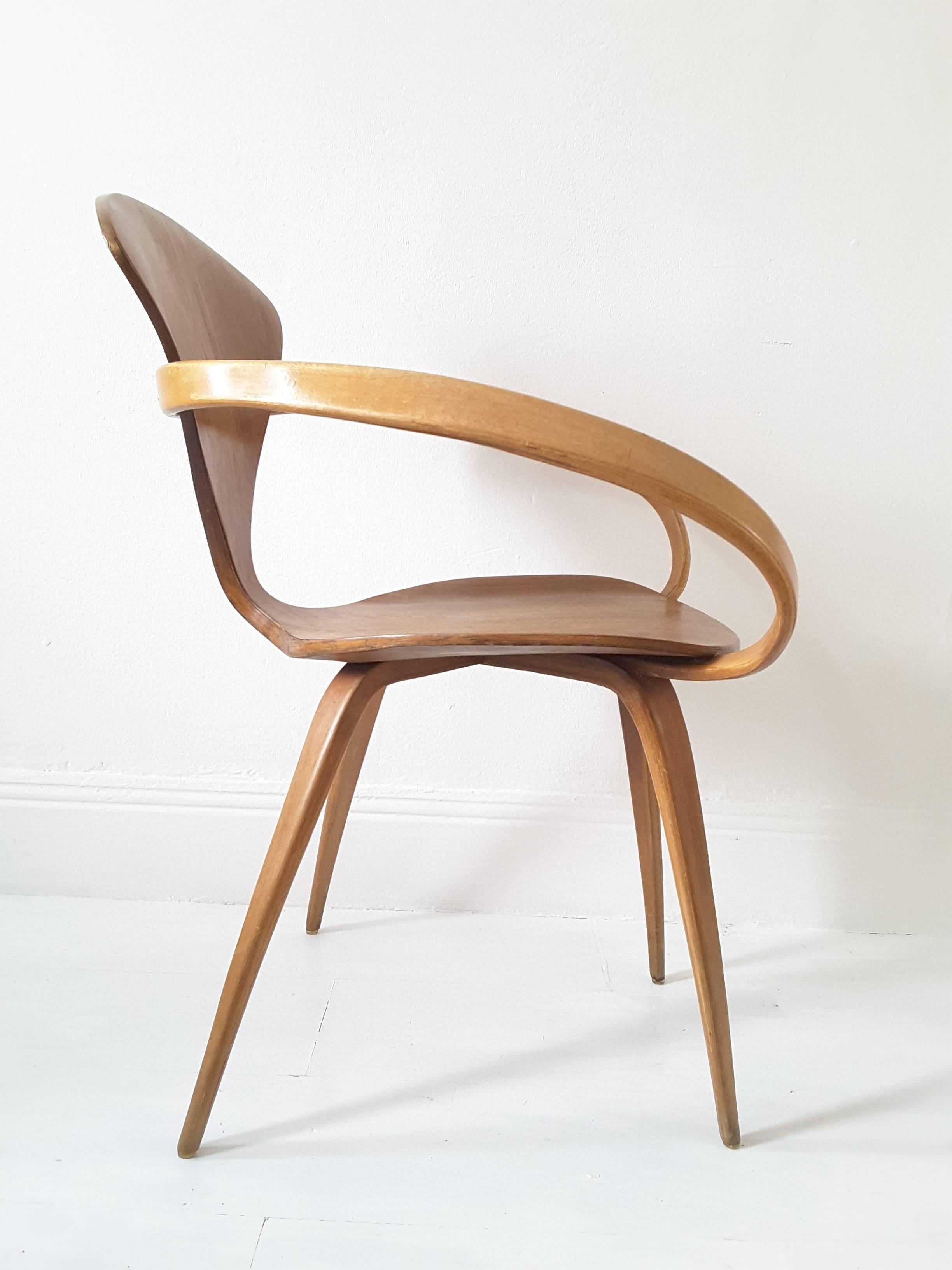 An original 1950s Cherner chair designed by Norman Cherner and produced by Plycraft. Bent plywood construction in beech and walnut. Retains foil label beneath.