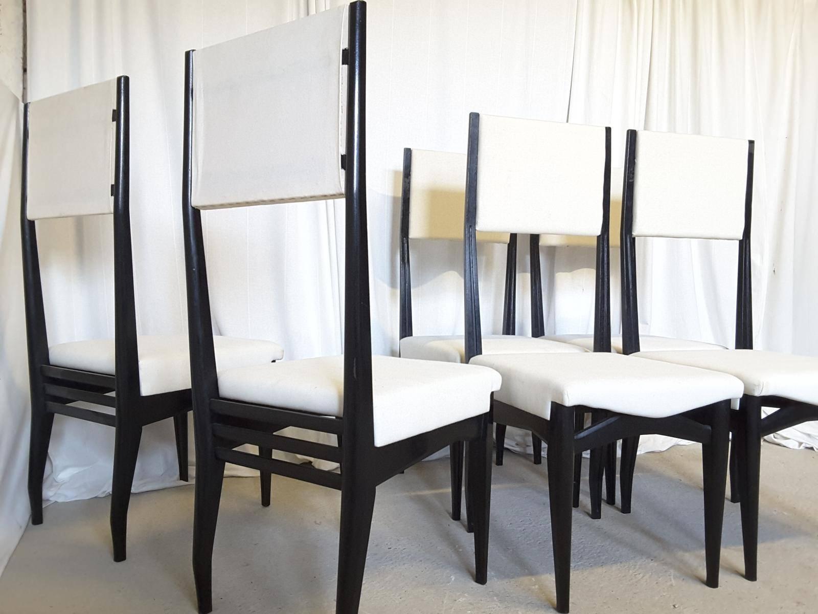 A set of six Italian high back dining chairs. Lift off seat pads re-webbed and lined with linen. Solid ebonized wood construction.