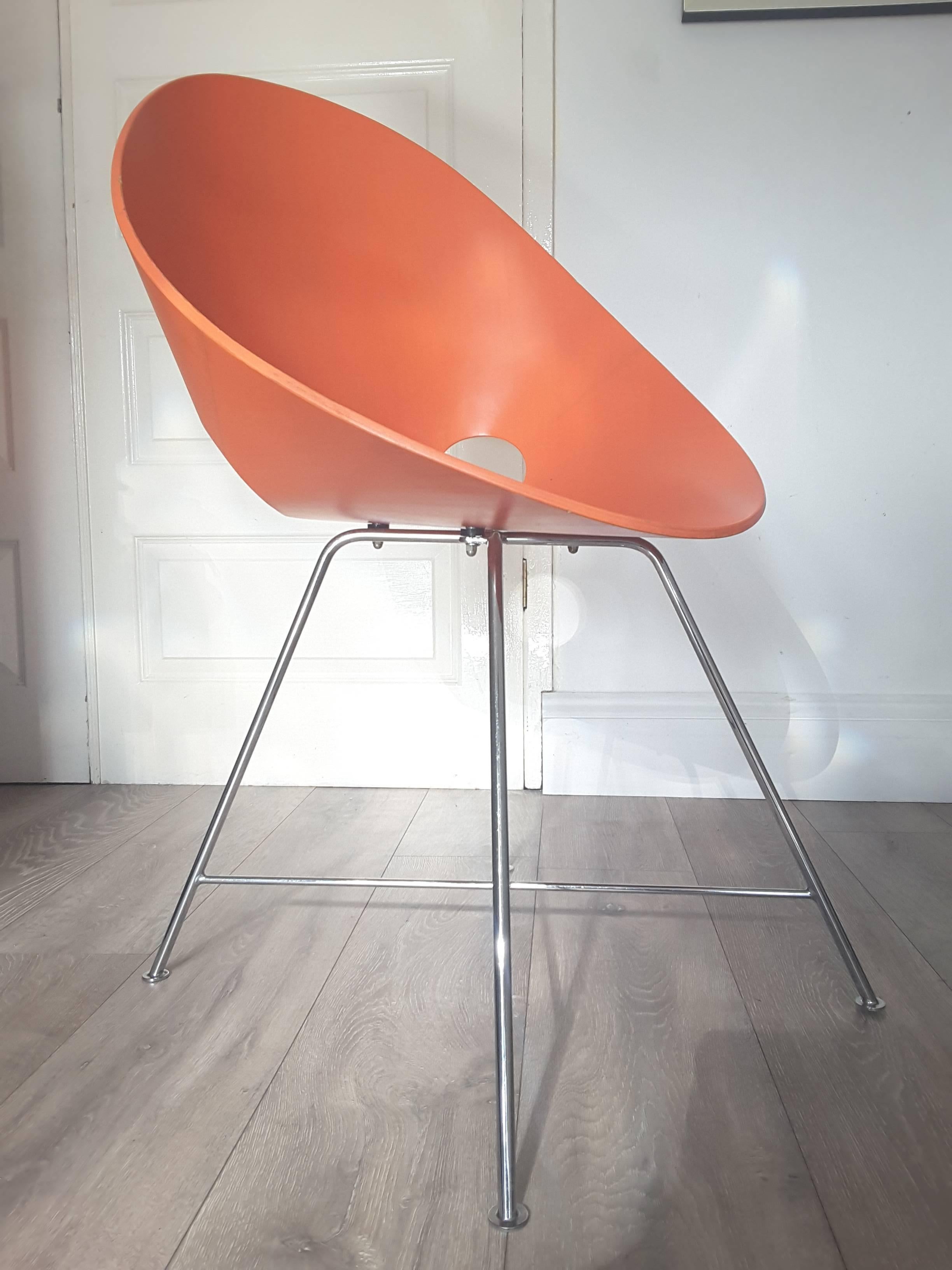 Designed by Eddie Harlis for Thonet. Bent plywood shell in original orange with chromed base. Excellent condition with only minor rub marks to edges. Retains Thonet label. The base unscrews easily for safe shipping. Pair available.