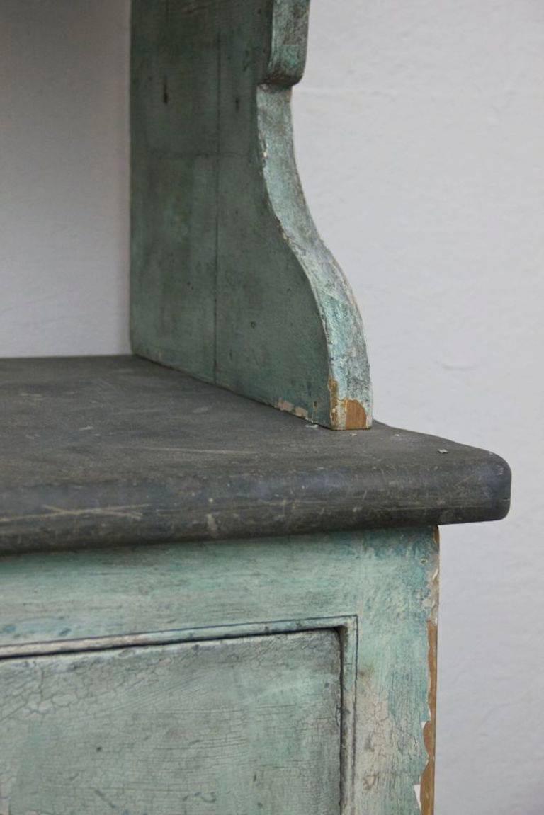 An unusual 19th century kitchen dresser with wavy glazed doors and a wonderful slate top.