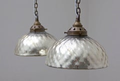 A pair of mercury glass pendant lights