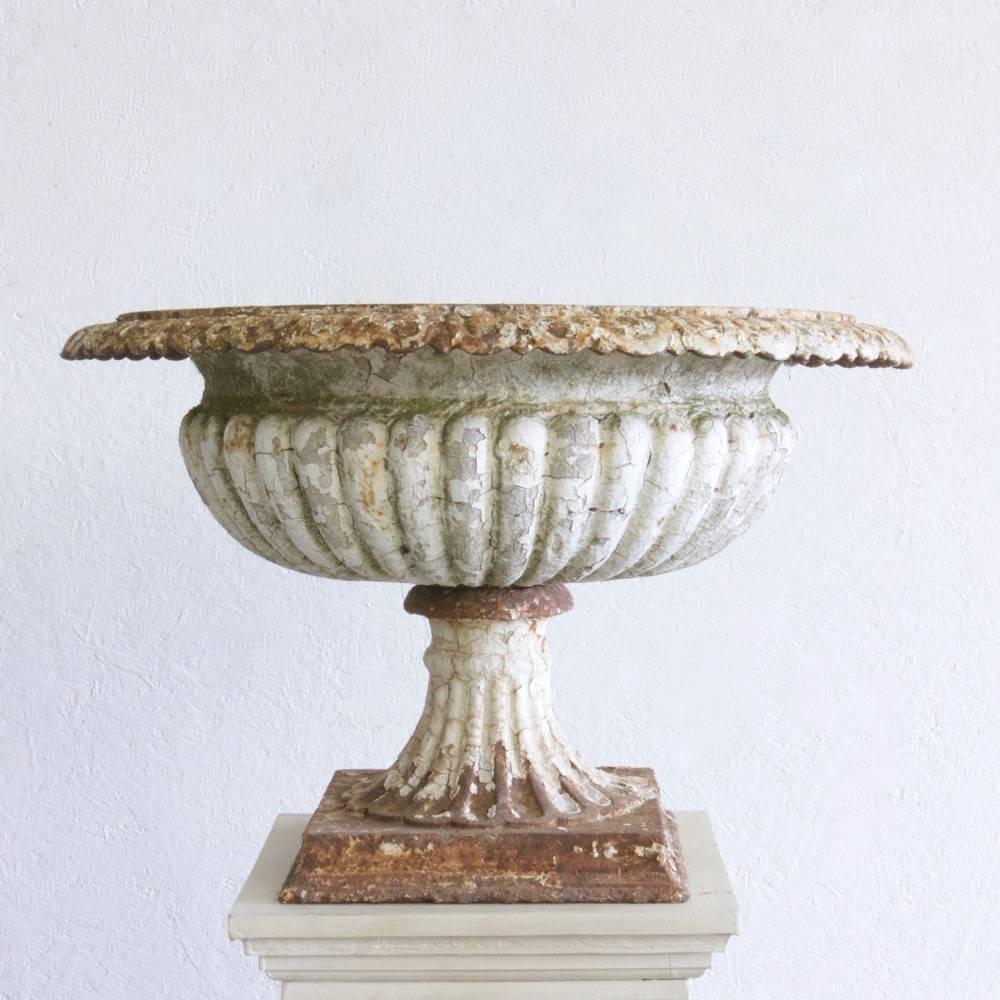 A great 19th century cast iron campagna urn retaining its original decoration. England, circa 1860.
  