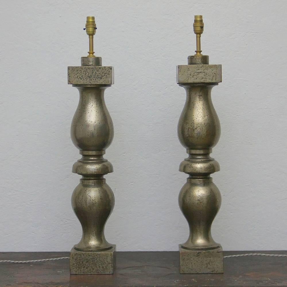 A striking pair of 19th century polished iron baluster lamps, England, circa 1880. Wired and pat tested.
 