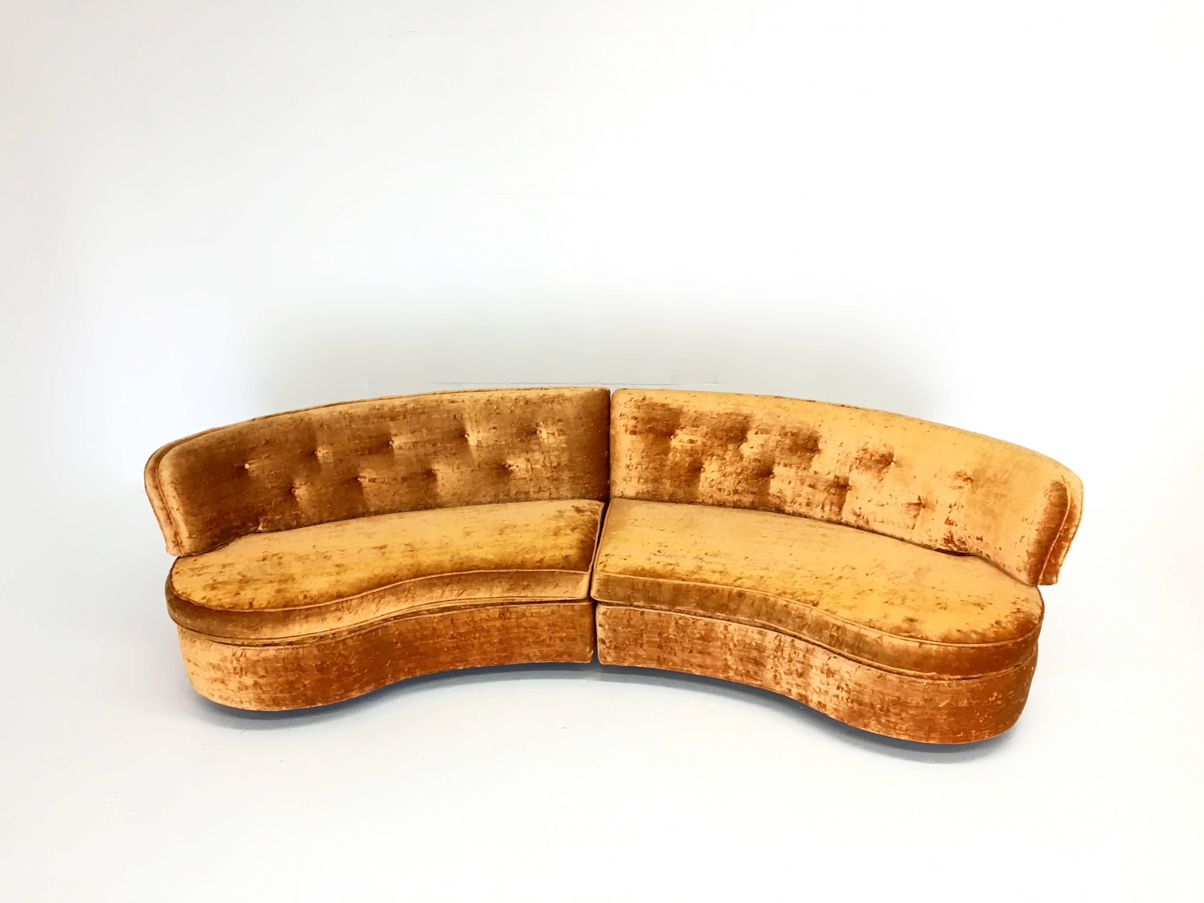 What a gorgeous, sexy sofa! This curved sofa is in super condition in an orange crushed velvet. The cushions could be replaced since they are quite firm. The fabric is in very good condition, though some may want to reupholster. The shape of the two