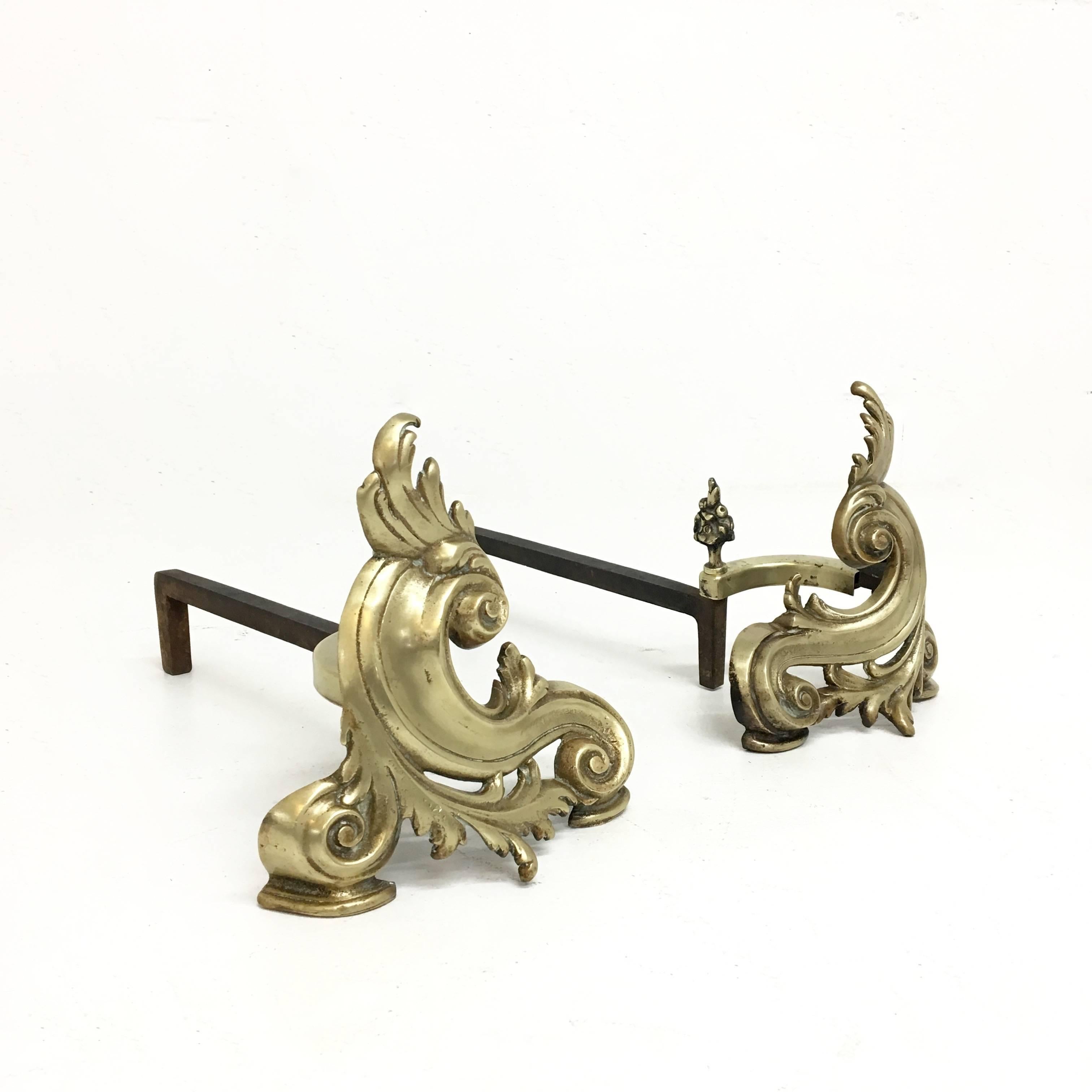 Decorative pair of brass chenets or andirons form the late 19th century in the style of Louis XV with Baroque flourishes.
