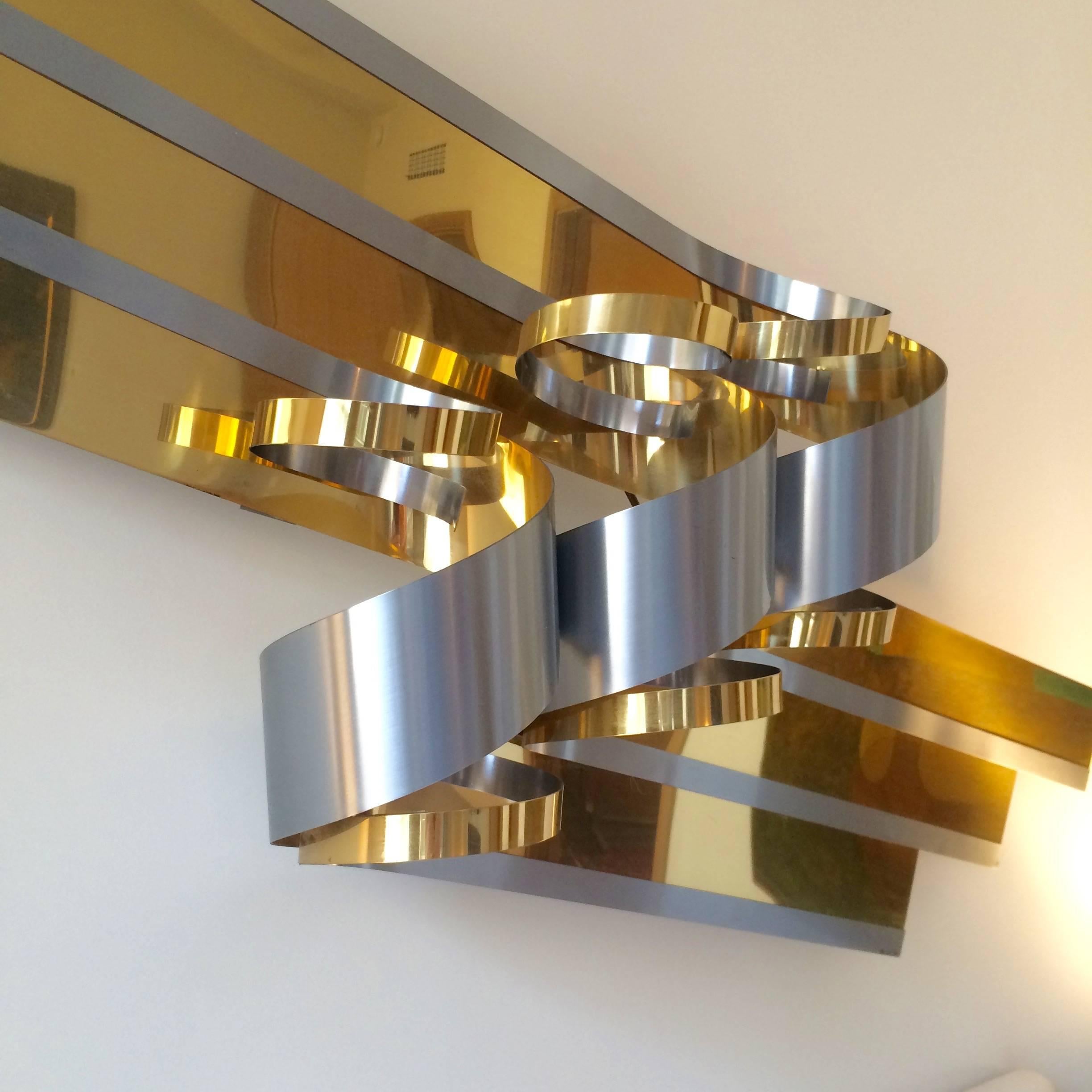 Large brass and brushed steel ribbon sculpture by Curtis Jere. This sculpture is dated and signed C. Jere '89.
 
