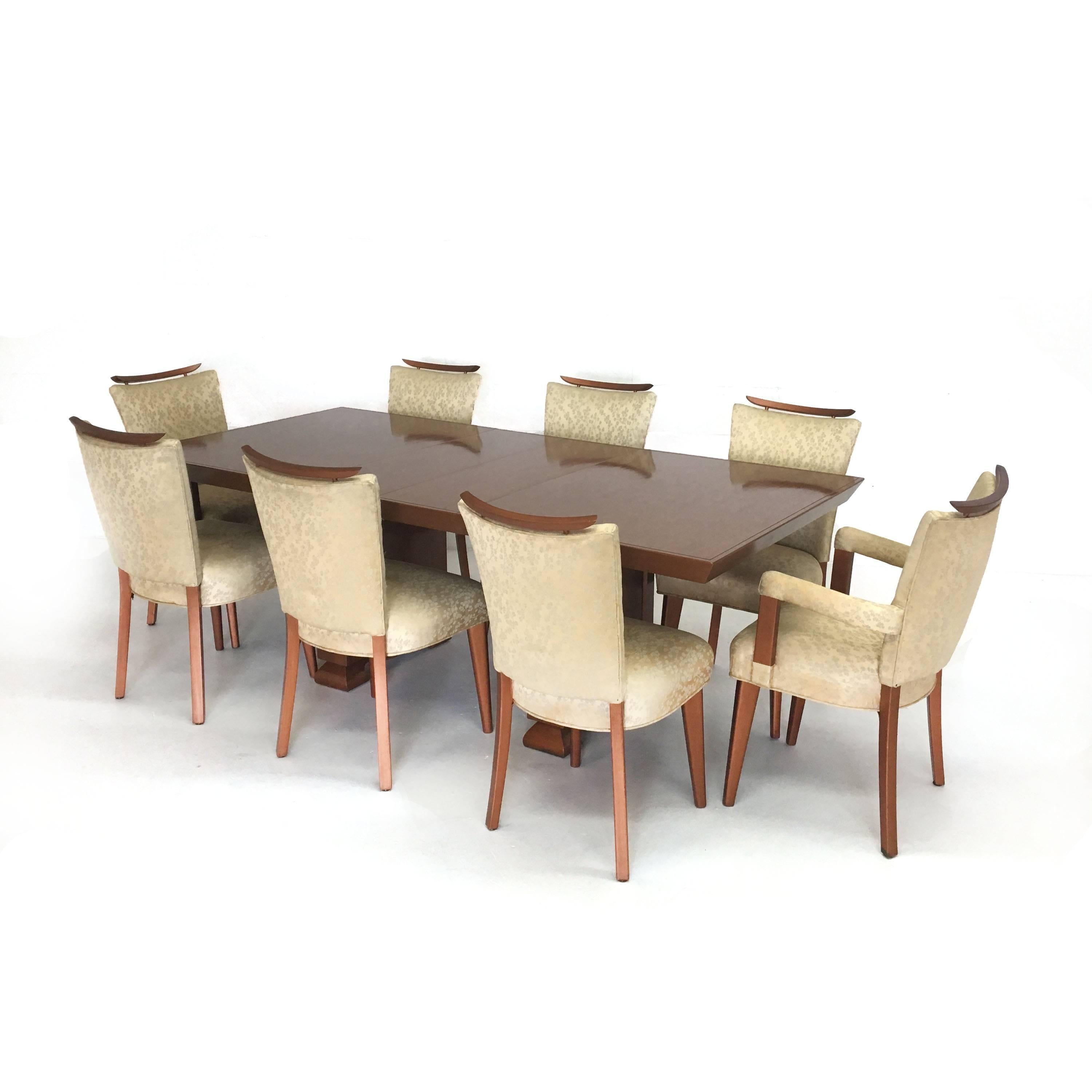 Rare Mid-Century dining table and eight chairs in the style of James Mont in a copper finish. Table comes with two leaves expanding to 83.5