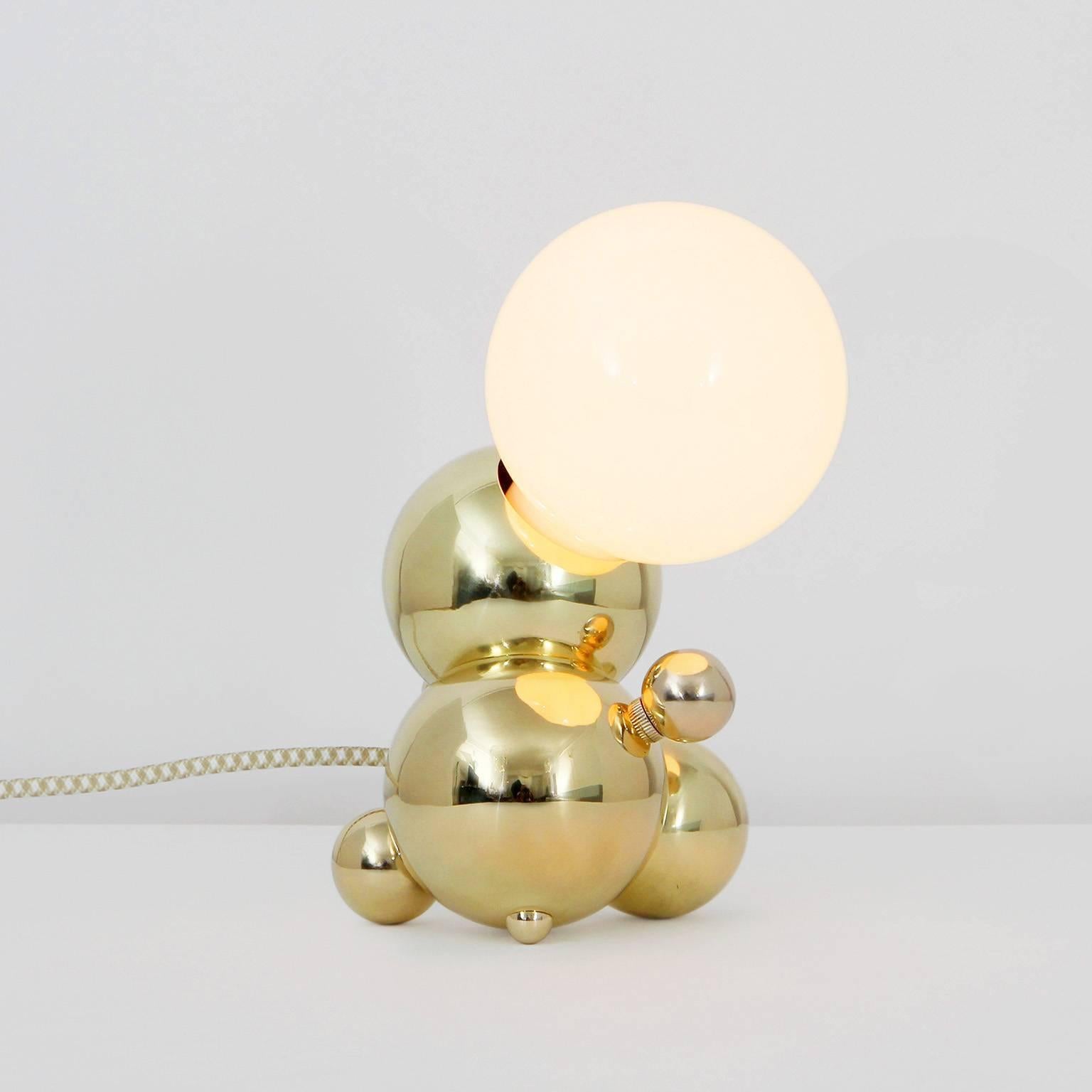 Bubbly is an effervescent all-brass lighting system inspired by soap bubble clusters and Newton's laws of universal gravitation. The modular system comprises discrete brass spheres, meticulously assembled to form abstract organic fixtures