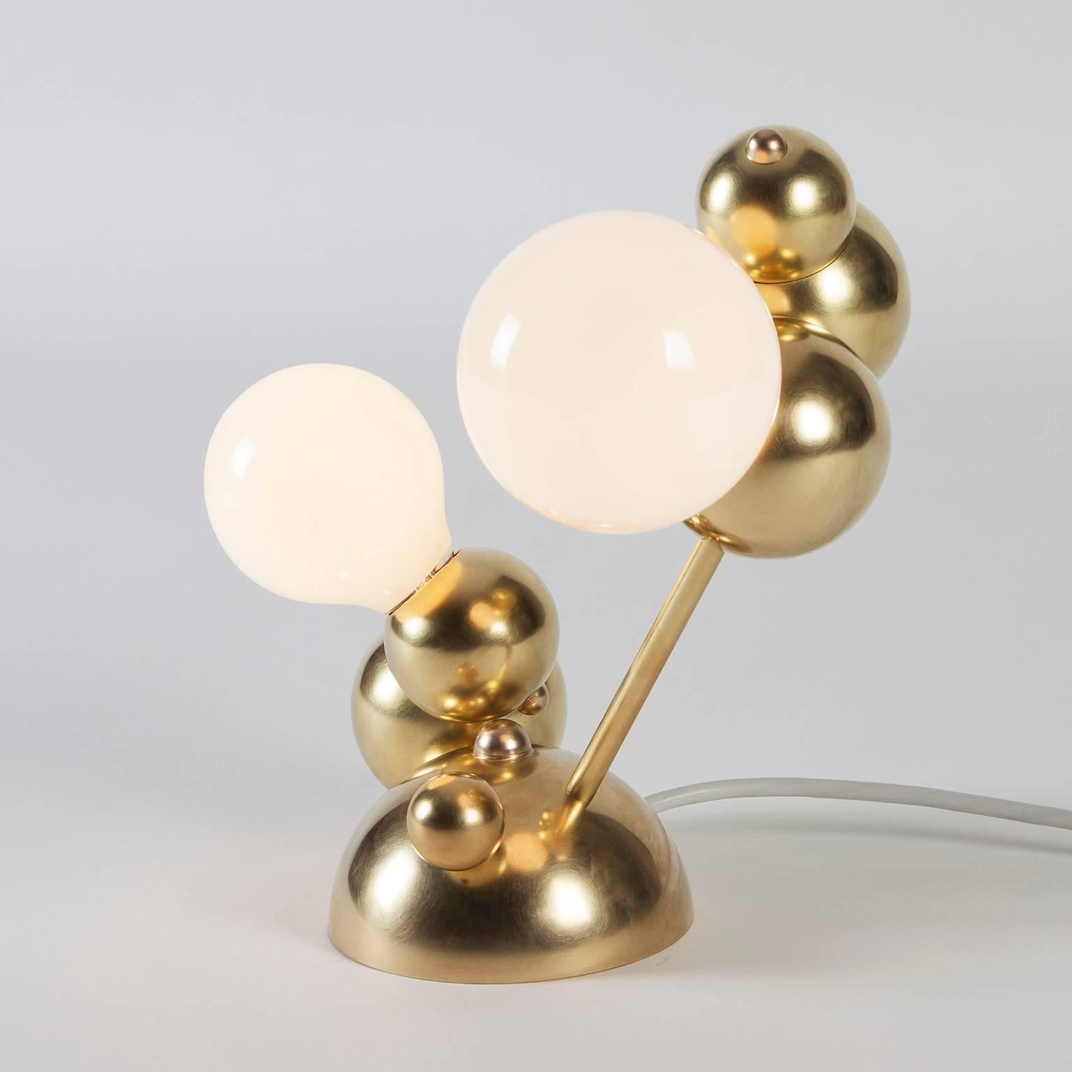 Bubbly is an effervescent all-brass lighting system inspired by soap bubble clusters and Newton's laws of universal gravitation. The modular system comprises discrete brass spheres, meticulously assembled to form abstract organic fixtures