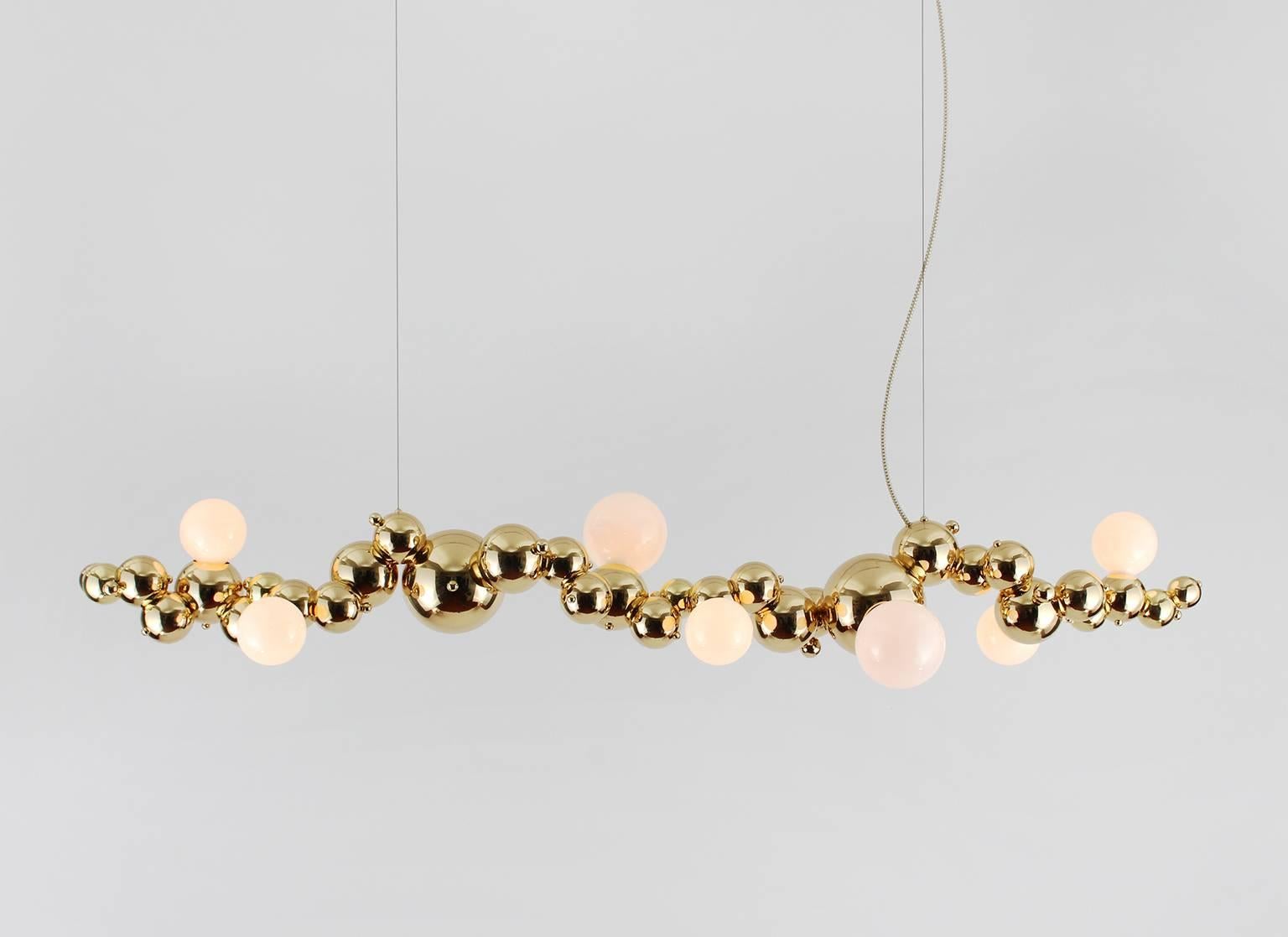 Bubbly is an effervescent all-brass lighting system inspired by soap bubble clusters and Newton's laws of universal gravitation. The modular system comprises discrete brass spheres, meticulously assembled to form abstract organic fixtures