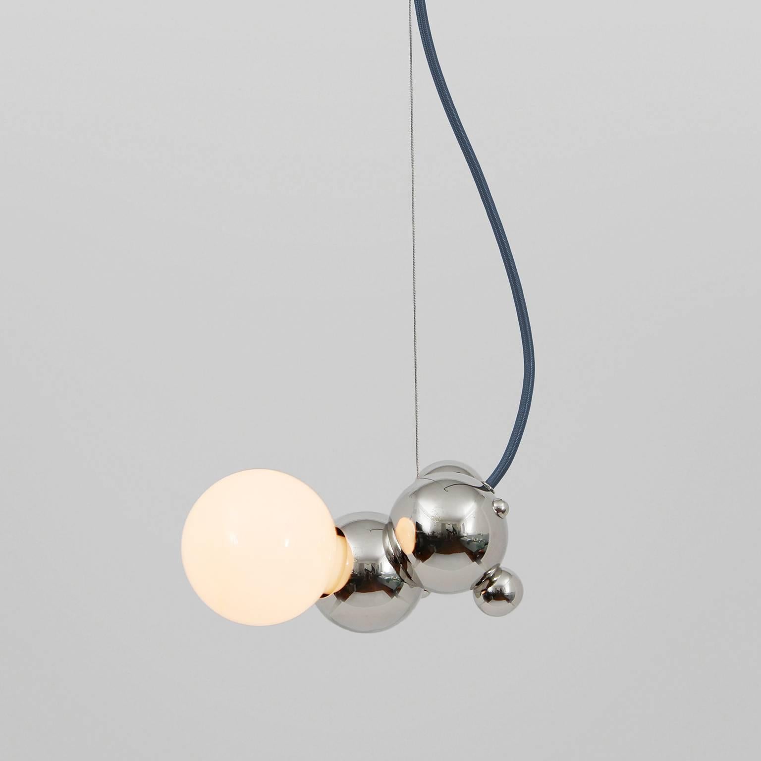 Bubbly is an effervescent, all-brass lighting system inspired by soap bubble clusters and Newton's laws of universal gravitation. The modular system comprises discrete brass spheres, meticulously assembled to form abstract organic fixtures