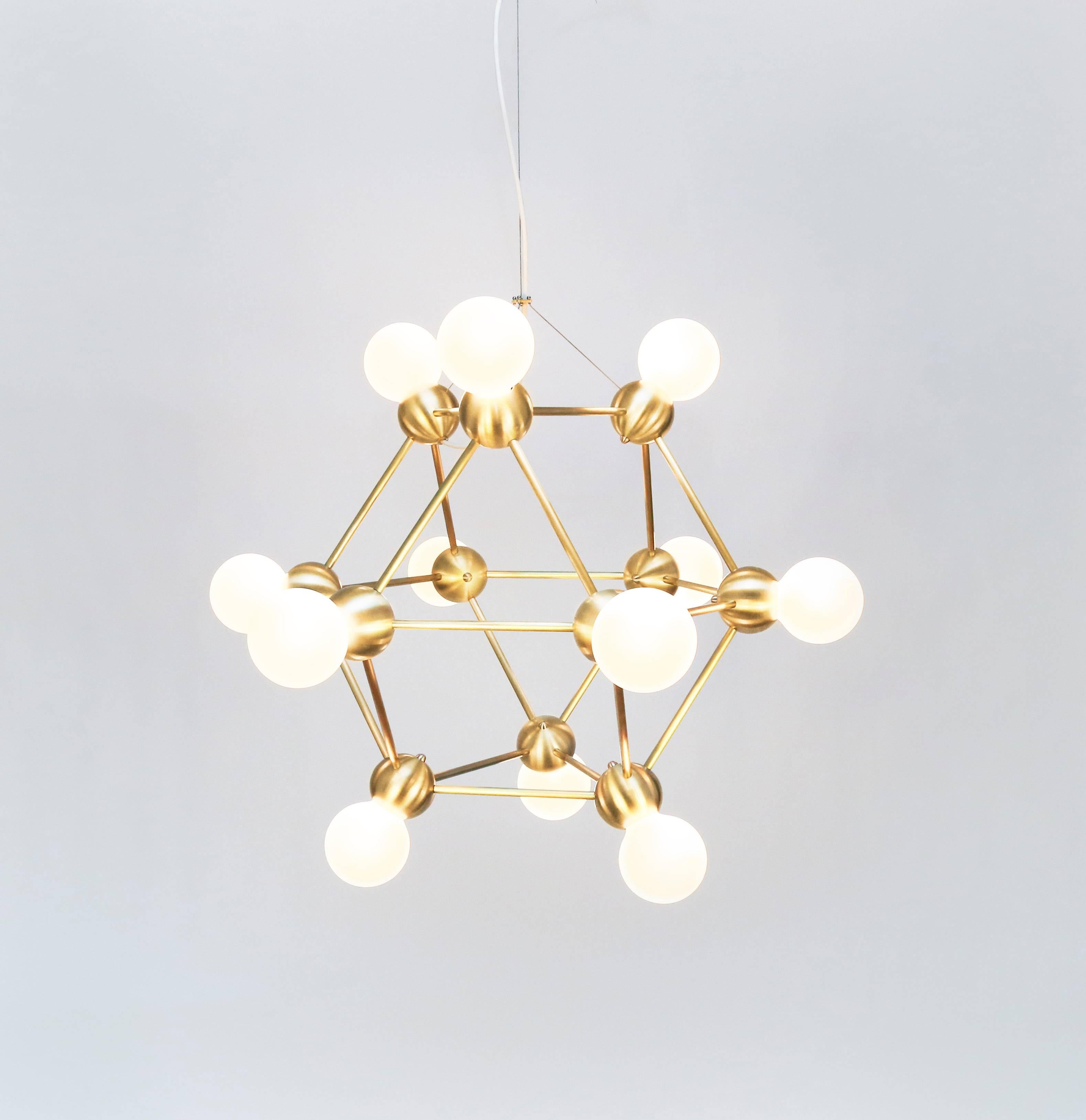 An airy, molecular brass chandelier inspired by 1960s Italian lighting. Part of the 